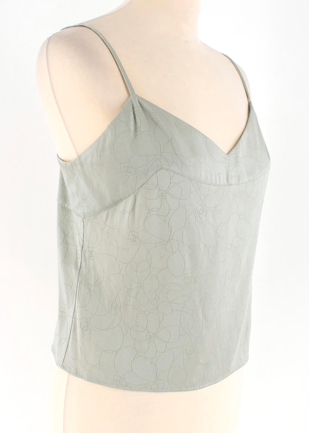 Chanel Mint Green Camellia Embroidered Camisole Top 

Mint green camisole 
Skinny strap
Monogram floral print 
Light weight 
Loose fit 
Single back button closure 
Black mother of pearl button 

All measurements are taken seam to