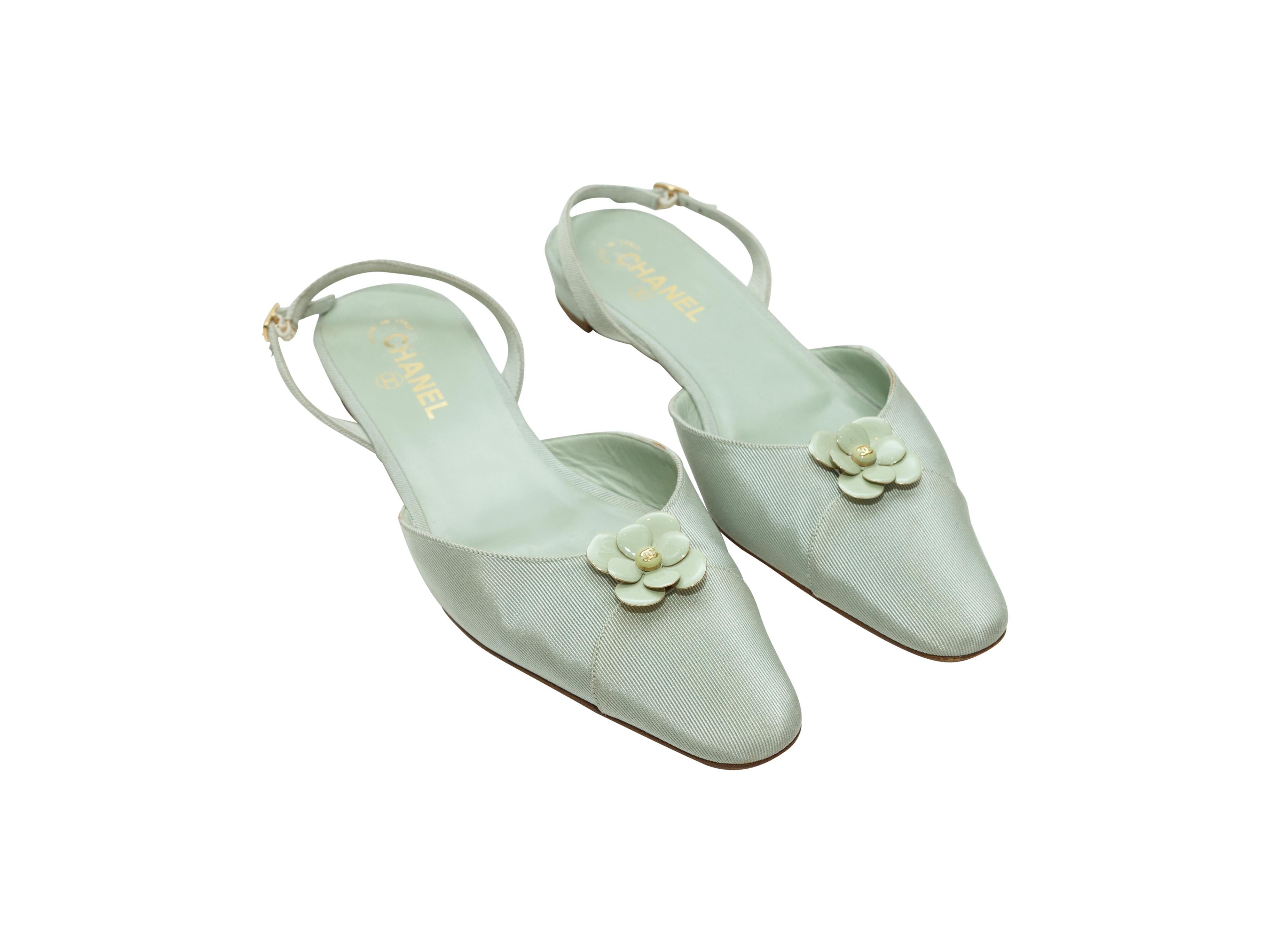 Product details: Mint green grosgrain pointed-toe flats by Chanel. Camellia adornments at toes. Gold-tone buckle closure at slingback straps. Designer size 40.
Condition: Pre-owned. Very good. Light wear. Minor marks at grosgrain.
Est. Retail $