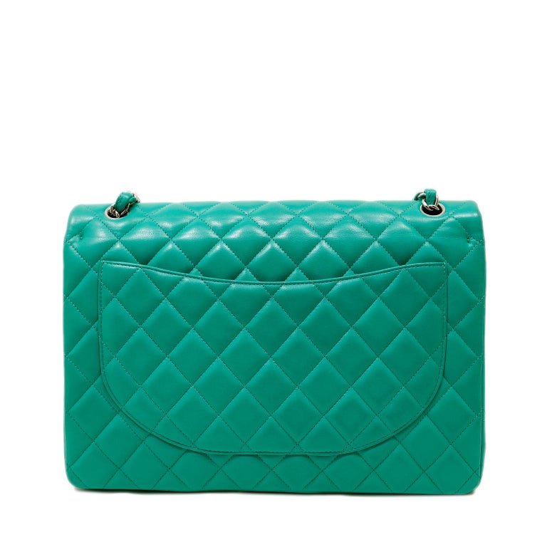 This authentic Chanel Mint Lagoon Lambskin Maxi Flap Bag is in pristine condition. The breathtaking color in the Maxi silhouette is a brilliant addition to any collection.
Vibrant mint lagoon lambskin is quilted in signature Chanel diamond pattern. 