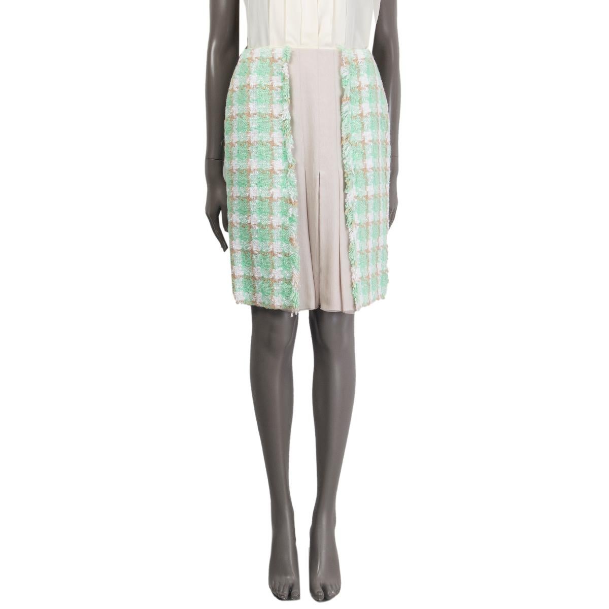 100% authentic Chanel tweed skirt in mint, beige and white vicose (55%), cotton (26%) and wool (19%) with pale grey box pleated silk chiffon panel in the front. Opens with a zipper in the back. Lined in silk (with 5% elastane). Has been worn and is
