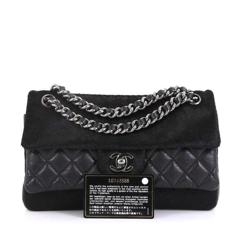 This Chanel Miss Pony Double Flap Bag Quilted Aged Calfskin and Pony Hair Medium, crafted from black quilted aged calfskin and pony hair, features woven-in leather chain straps, exterior back slip pocket, and gunmetal-tone hardware. Its CC turn-lock