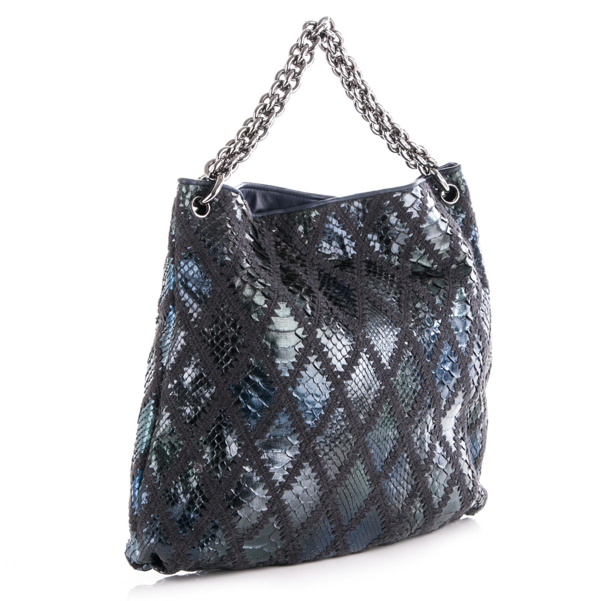 Chanel metallic blue exotic python hobo with chunky chain handle.

2007 {VINTAGE 15 Years}
Silver hardware
Metallic blue python 
Crochet diamond stitching
Thick chunky chain detail
17