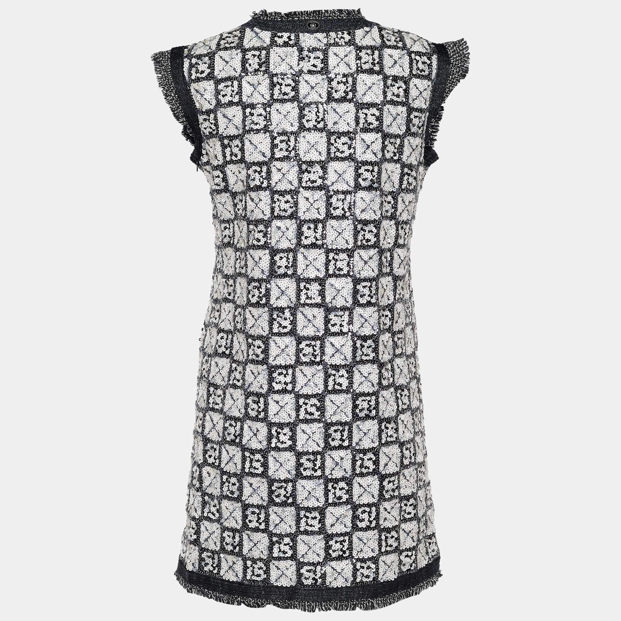 Get ready for the evening and look like a diva as you don this fabulous dress from the House of Chanel! Fashioned in sequin-embellished fabric, this mini dress is highlighted with a check pattern. It is provided with a zipper. Make a fascinating