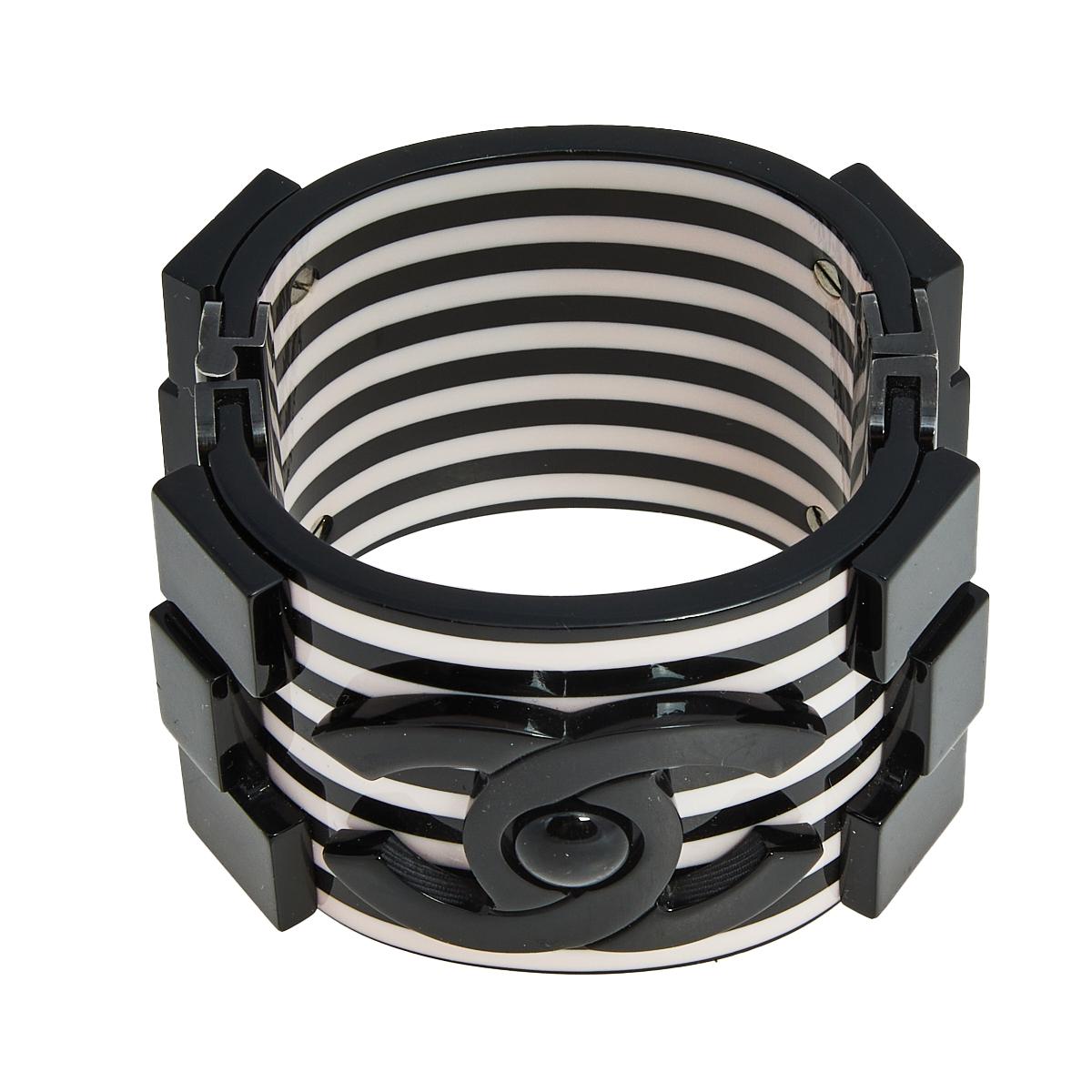 Constructed using black-tone metal and resin in a cuff design, this Chanel bracelet is sure to fit well and look great on your wrist. It comes in its original box.

Includes: Original Box