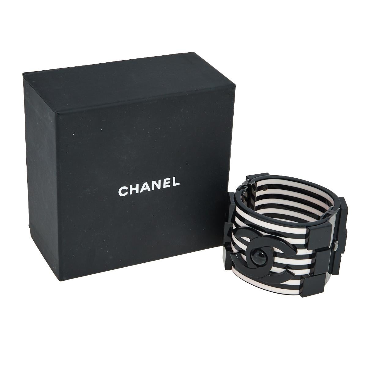 Constructed using black-tone metal and resin in a cuff design, this Chanel bracelet is sure to fit well and look great on your wrist. It comes in its original box.

Includes: Original Box
