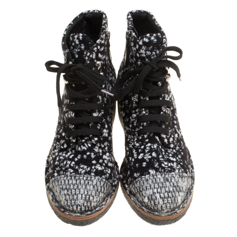 How stylish, modern and chic do these ankle boots from Chanel look! They are crafted from monochrome tweed fabric and feature round cap toes, lace-ups on the vamps, a CC logo detailing on the heel counters, comfortable leather lined insoles and 5 cm