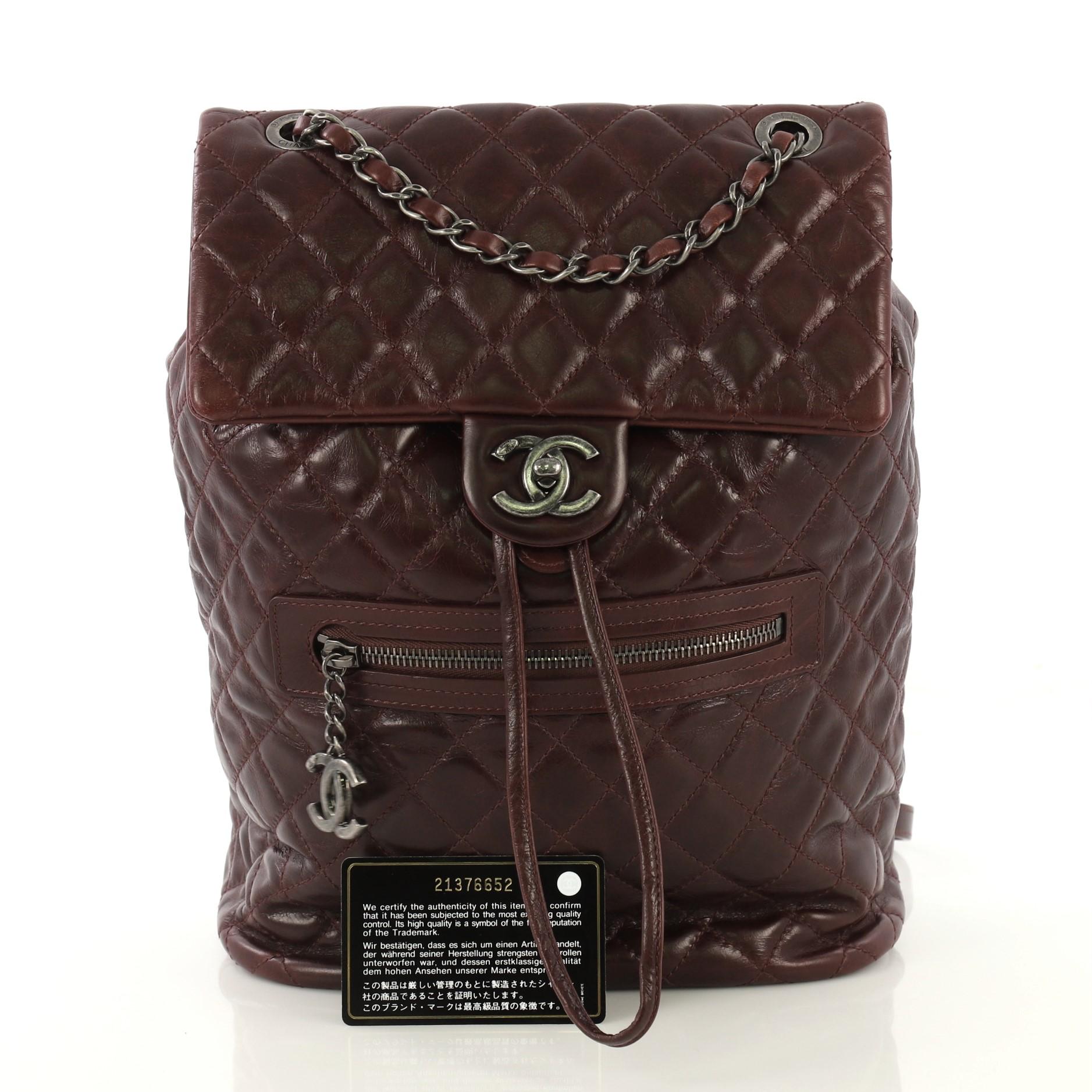 This Chanel Mountain Backpack Quilted Glazed Calfskin Large, crafted from purple quilted glazed calfskin, features woven-in leather chain top handle, flat leather backpack straps, an exterior front pocket with CC logo zipper, exterior back slip
