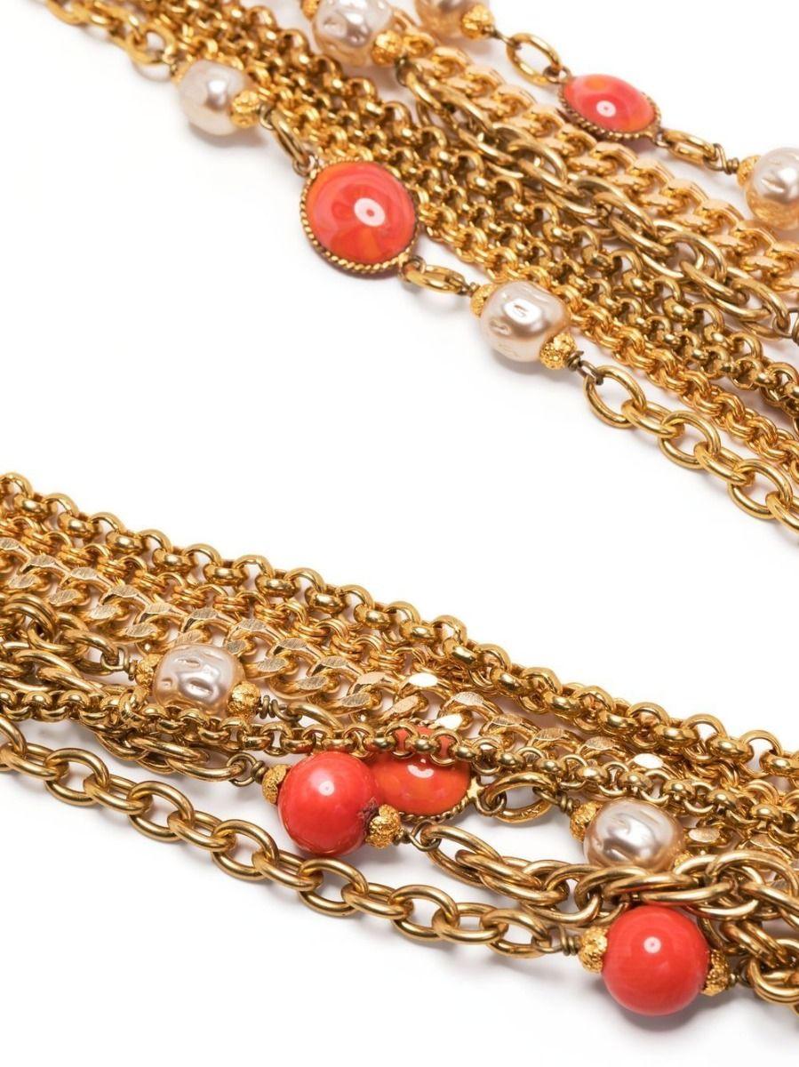 Designed by Gripoix in the style of Chanel, this vintage necklace displays layers of various style golden chains with baroque pearls and coral beads. Secured using a springing fastening, this unique necklace has been finished with a single coral