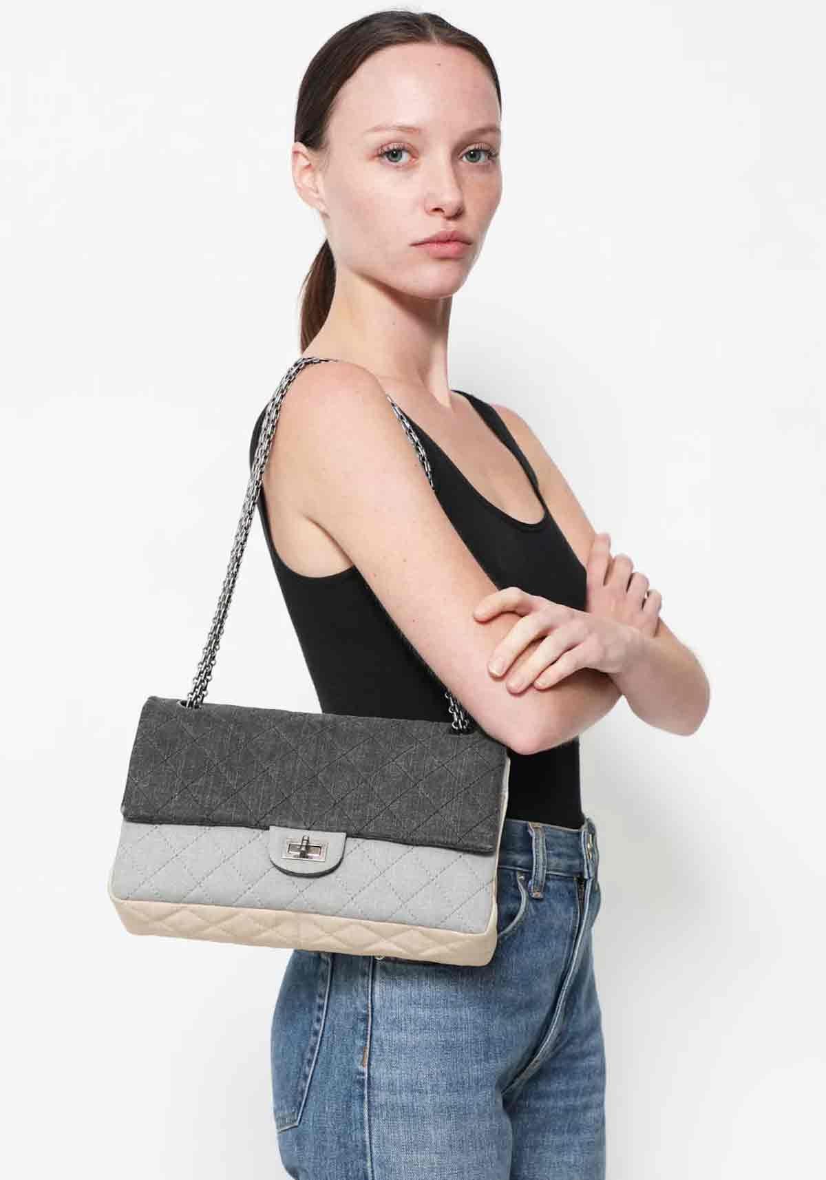 Chanel Multi color large canvas denim quilted flap with reissue turnlock hardware and classic reissue chain

Year: 2009 {VINTAGE 15 Years}
Gold hardware
Classic back pocket
Interior flap with snap closure
Large zippered pocket on flap
Three