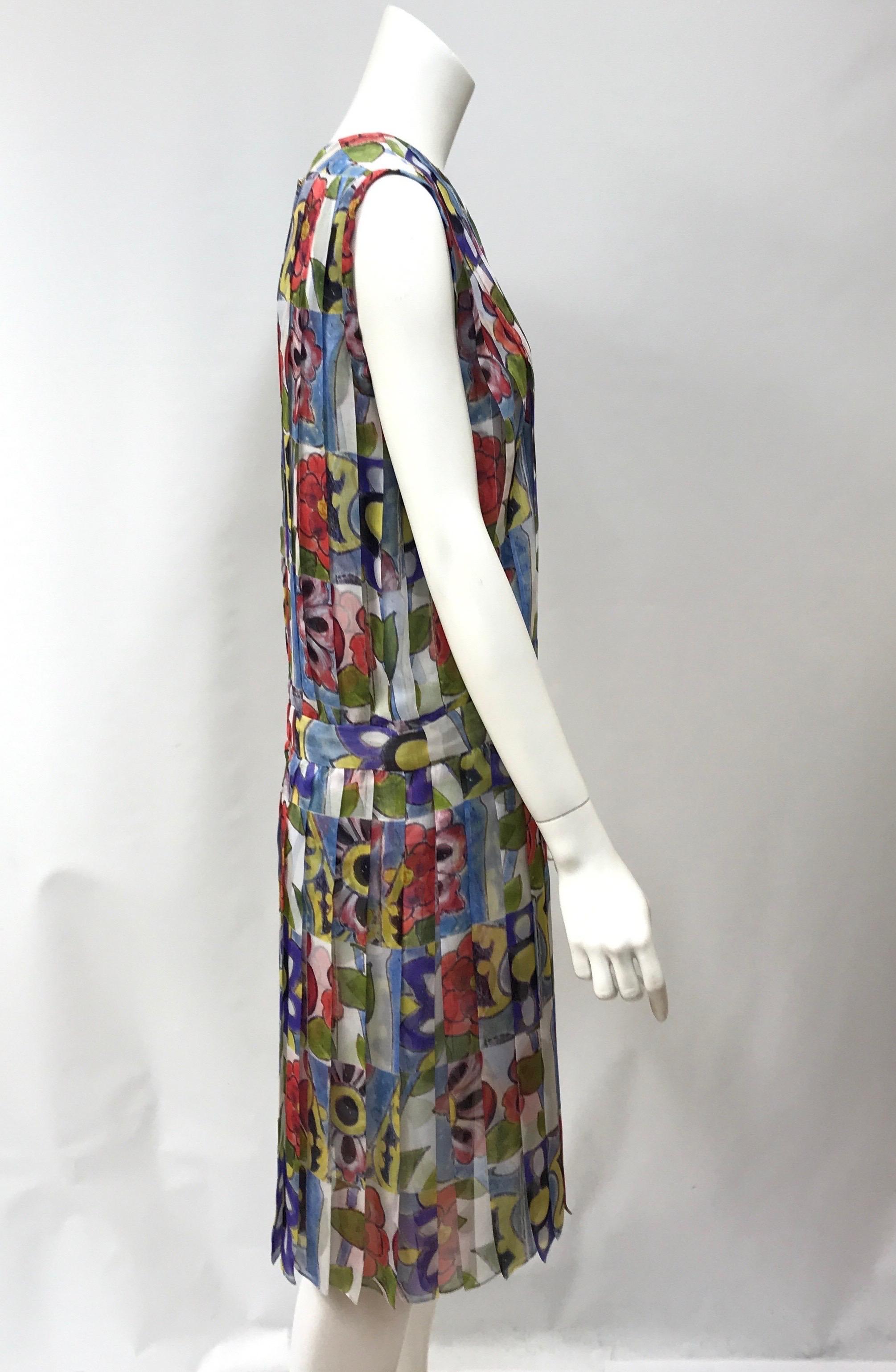 Chanel Multi Color Silk Floral Print Dress w/ Tucks-42. This beautiful Chanel dress is in excellent condition. There is no sign of use. It is made of 100% silk and has a colorful floral print throughout. The dress has no sleeves and zips up in the