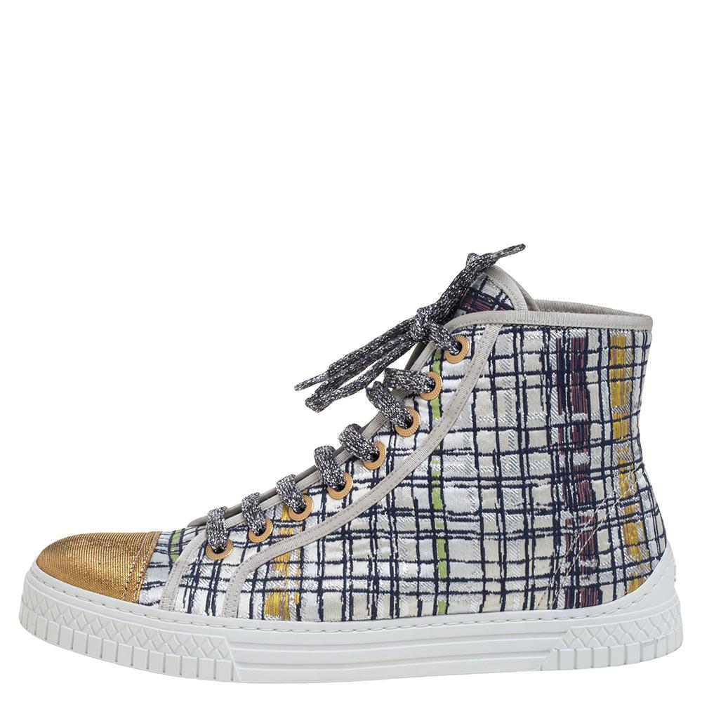 Bring home the luxurious high-fashion touch with these high-top sneakers from Chanel. Crafted from multicolor brocade and gold lame fabric, these sneakers flaunt cap toes, lace-ups on the vamps, CC logo detailing below the counters, and tough rubber