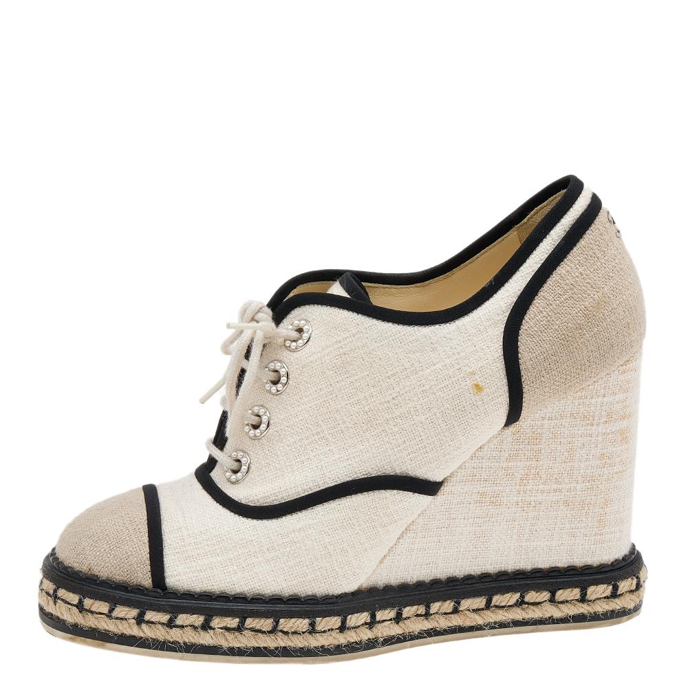 These sneakers from Chanel are both stylish and comfortable! They are crafted from canvas and designed in a round-toe silhouette. They are equipped with lace-ups and stand tall on 10 cm wedge heels.

Includes: Original Dustbag