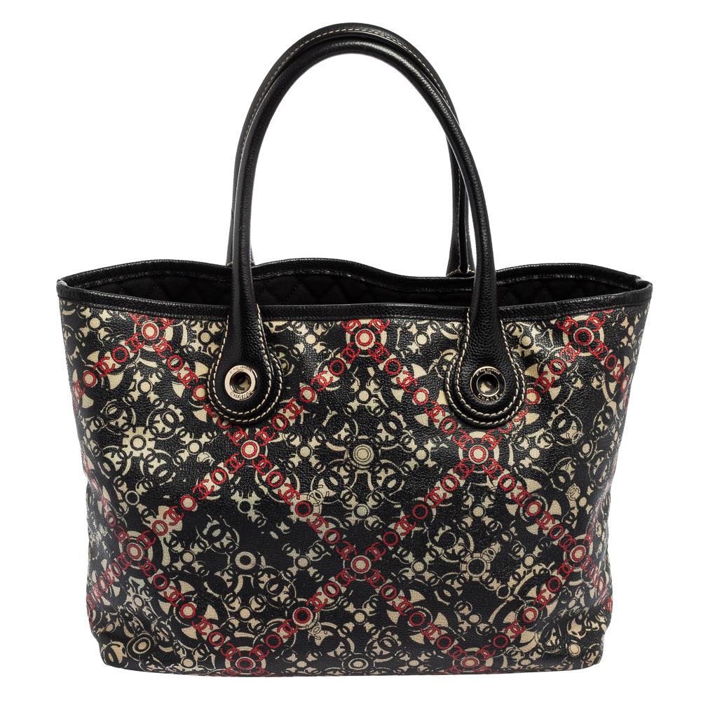 This Chanel tote is a fine piece that will never go out of style. The bag is made from printed canvas and detailed with silver-tone hardware. This bag is designed to easily fit your belongings. You can parade it via the two top handles.

Includes: 