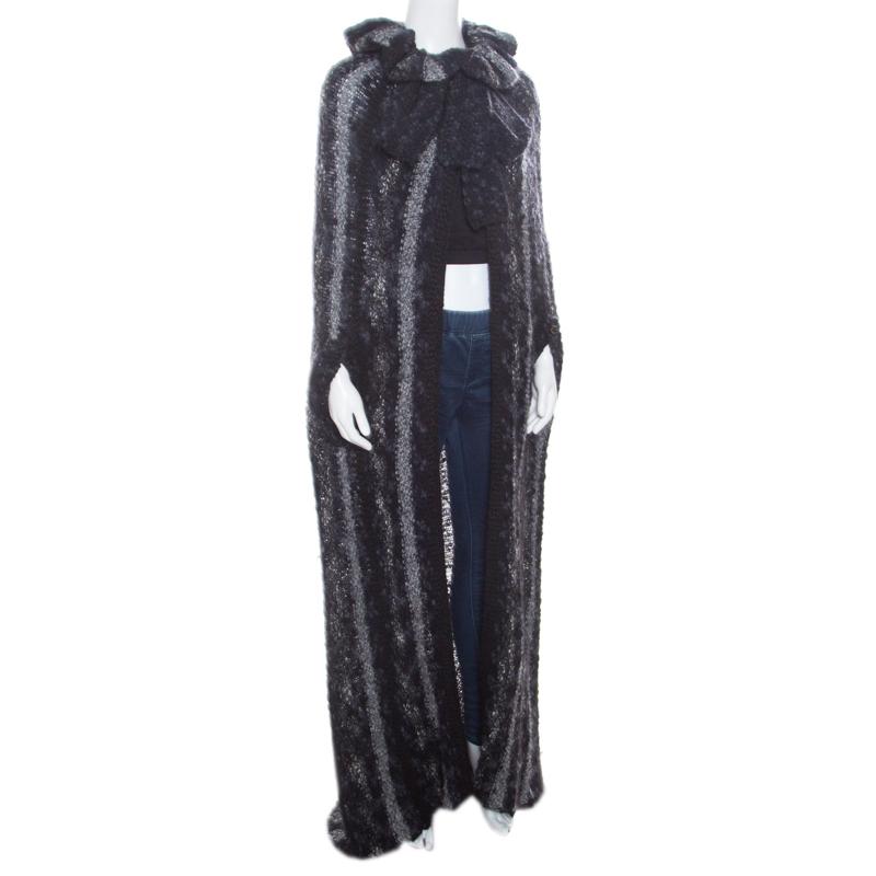 This Chanel cardigan is a versatile creation that definitely deserves a place in your wardrobe! It is made of a wool blend and features a chunky knit design. It flaunts an open front cape-style silhouette and wide collars with a tie detailing. Pair