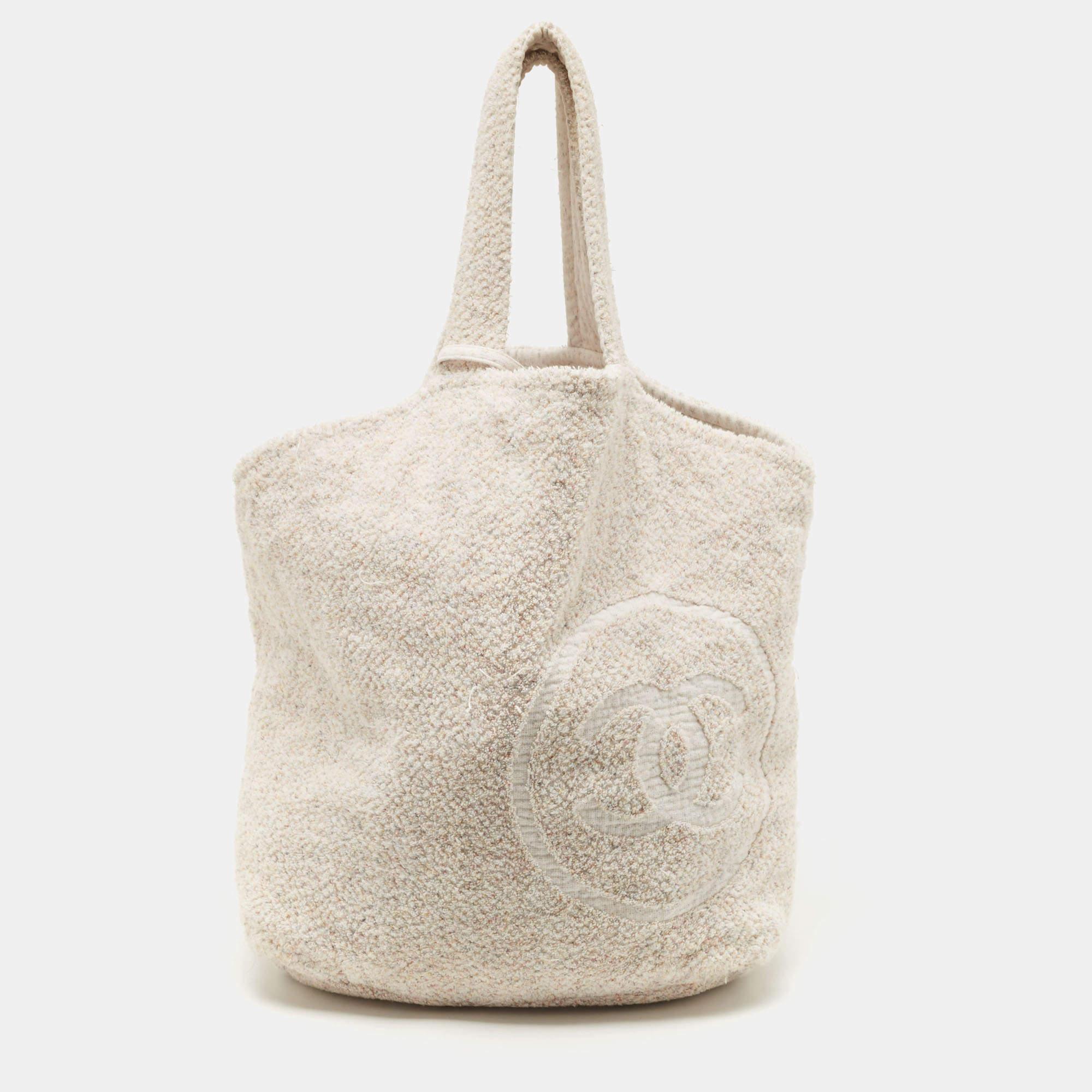 Get ready for a beach day in style with this Chanel beach bag and towel set. The large Chanel bag is made of cotton terrycloth and has two handles and a CC logo.

Includes: Pouch, Towel