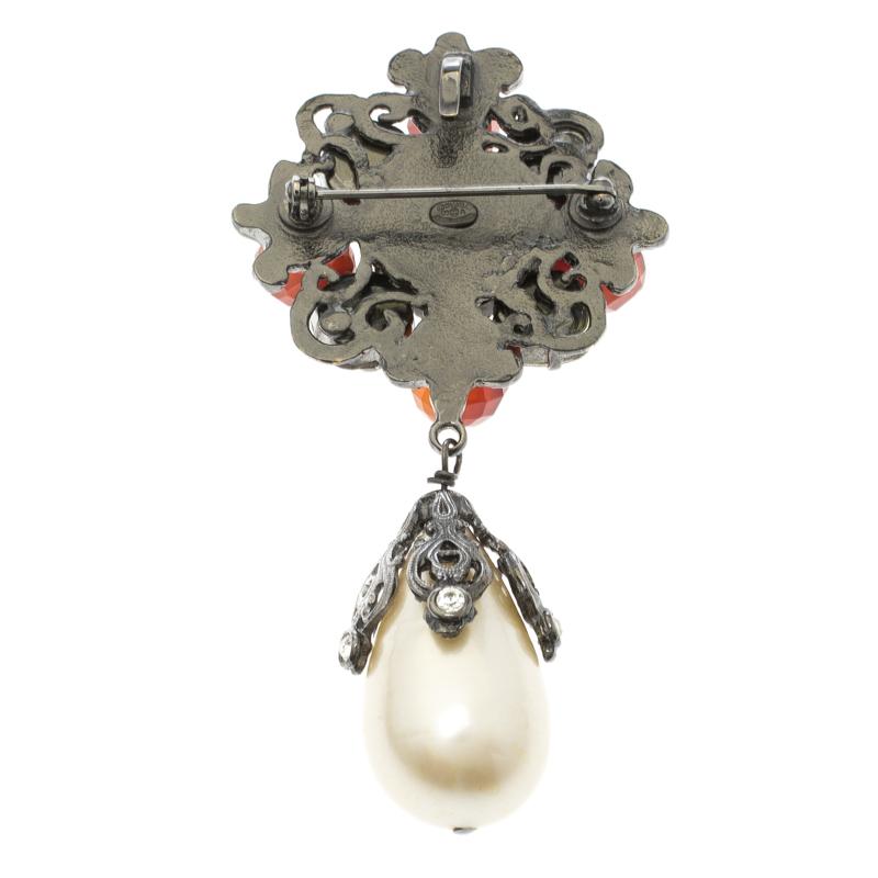A brooch has been known to add an instant touch of unique and chic look to your outfit with minimal effort. This Chanel brooch is crafted from silver-tone metal and features a beautiful crystal embellished flower motif accompanied by faux pearl drop