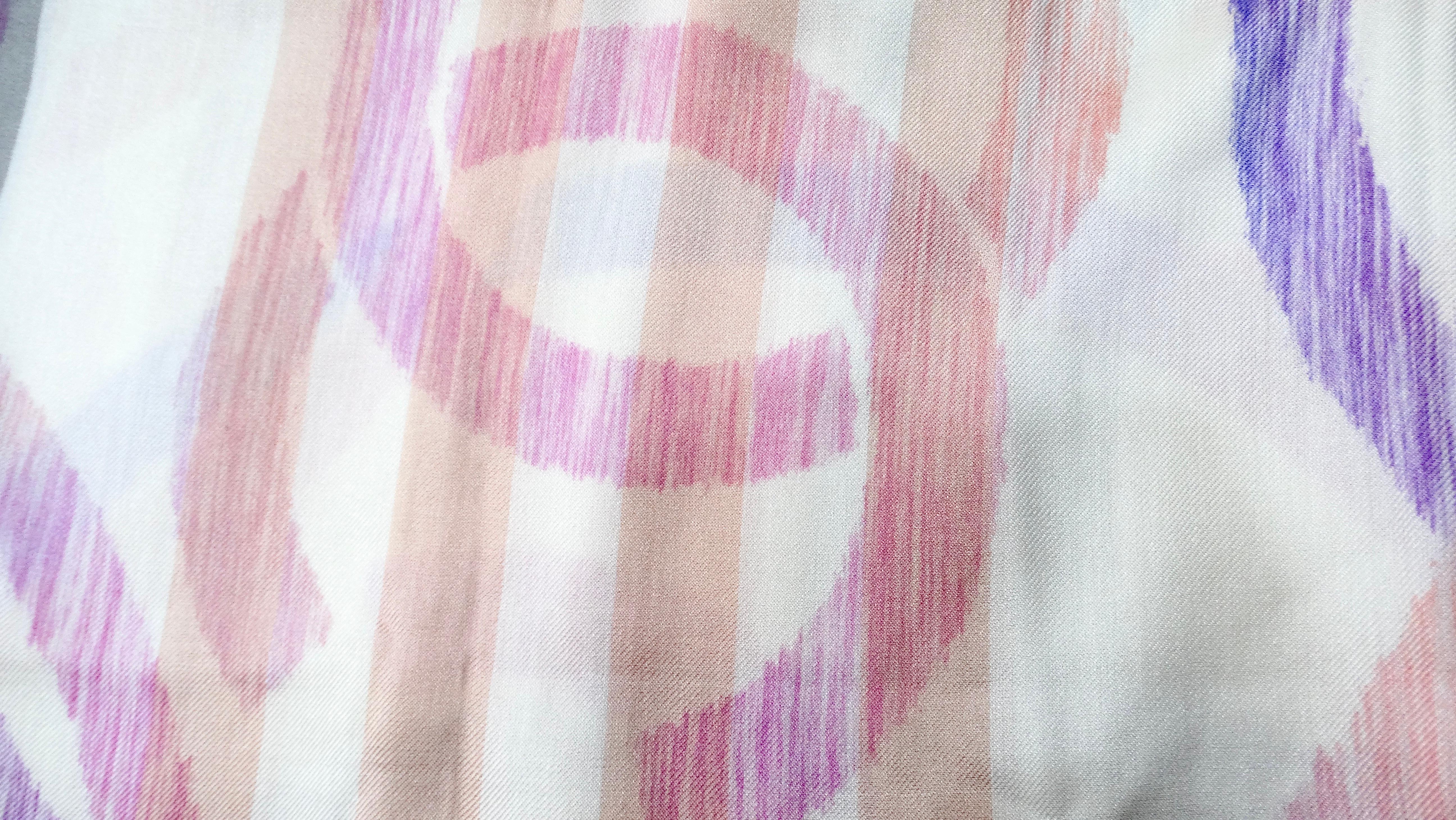 The Chanel Interlocking CC Printed Silk & Cashmere Pashmina Shawl is a luxurious and versatile accessory, perfect for elevating any outfit. Made from a sumptuous blend of silk and cashmere, this shawl features a stunning print that showcases a