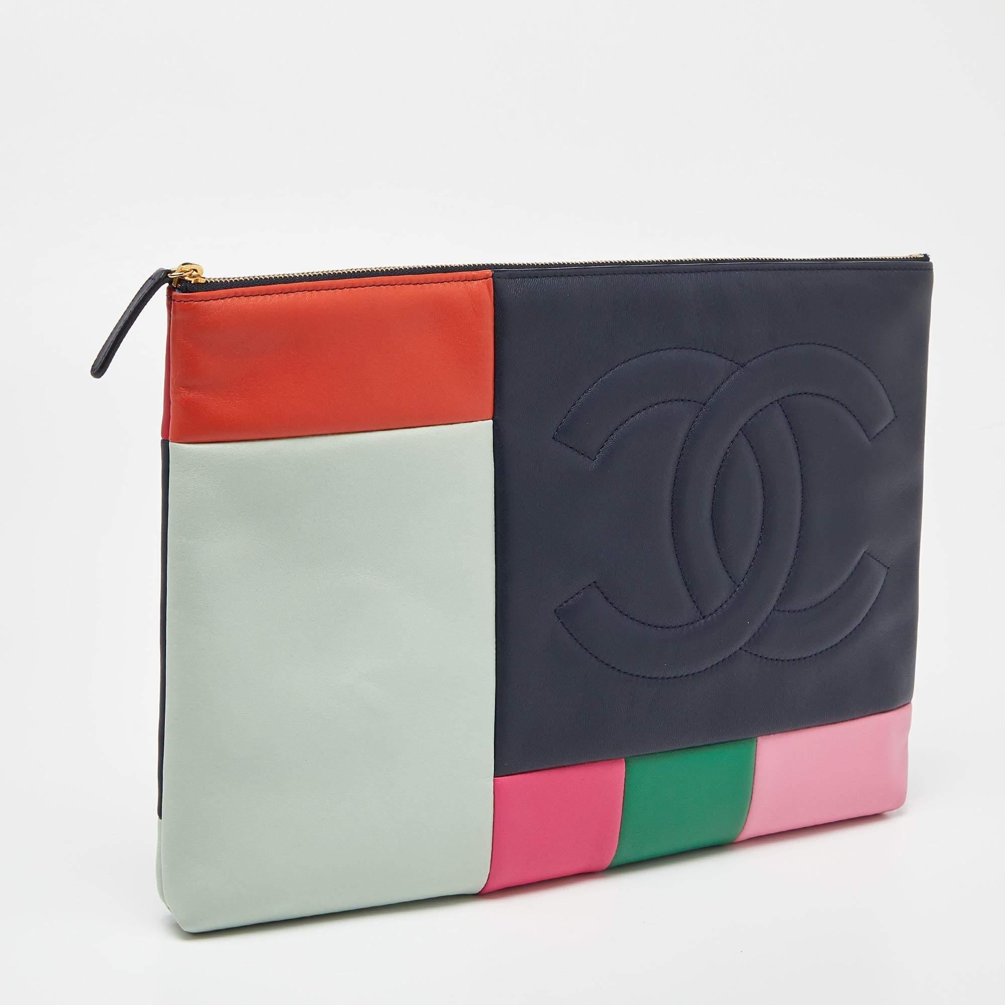 Chanel brings you the perfect day clutch! Crafted skillfully from leather into a patchwork design, the multicolored piece is adorned with a stitched brand logo on the front and has a zipper that opens into a well-sized interior to hold your