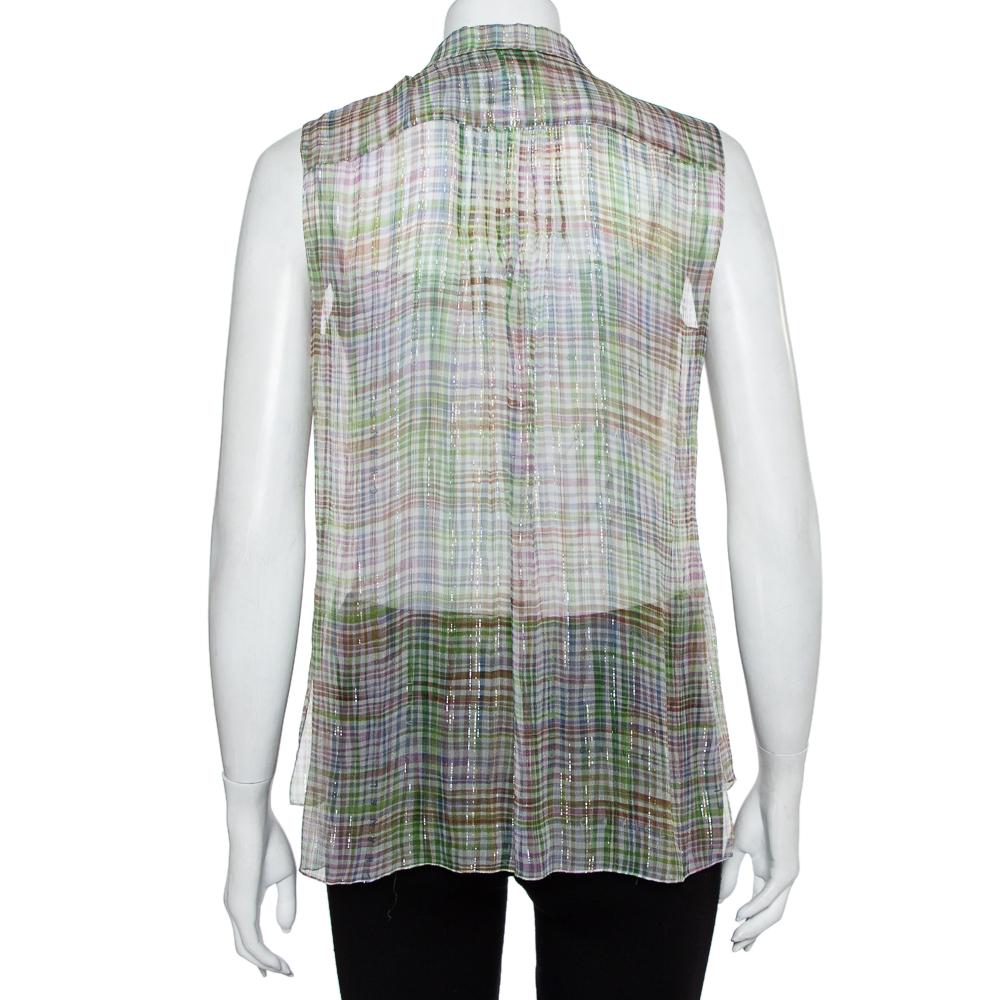 Have everyone marvel at this gorgeous shirt from Chanel! Made from silk this classic top is a must have in every wardrobe to add some contemporary appeal. This piece comes in multiple hues, a sleeveless design, and a buttoned front.

