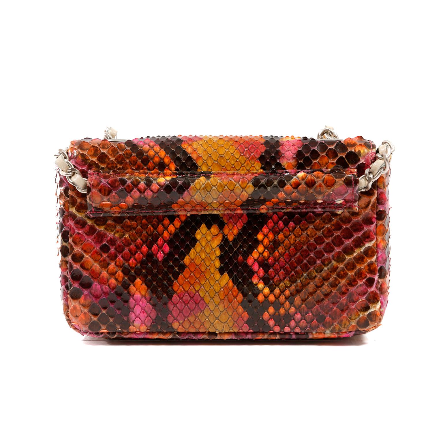This authentic Chanel Multicolor Python Mini Flap Bag is in excellent condition.  A fabulous versatile piece, it can be carried as a shoulder bag or worn as a belt. 
Brightly hued python skin mini flap bag in shades of orange and fuchsia.  Snap