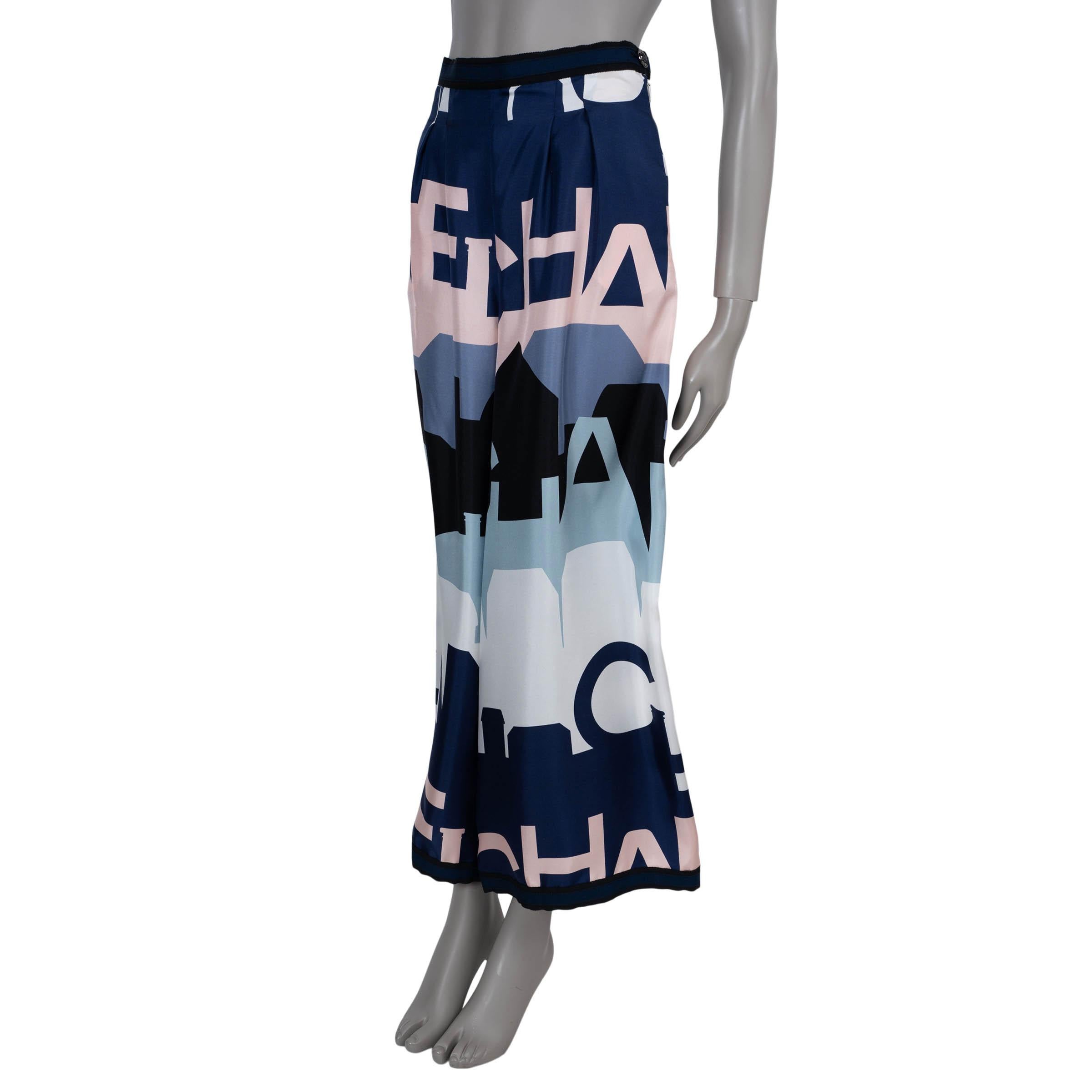 This 100% authentic Chanel pants in silk (100%) are a striking showcase of the house’s artistic flair. Featuring an allover print of the Chanel logo and Paris rooftop silhouettes in navy blue, grey, pale pink, black, and white, they are designed