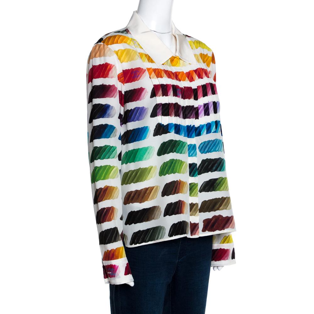 Exhibiting a playful and quirky design, this Chanel shirt is a closet staple. It features a bright multicolored print all over, a solid off-white colored collar, a discreet CC logo on the front and long sleeves. The shirt is cut from silk and is