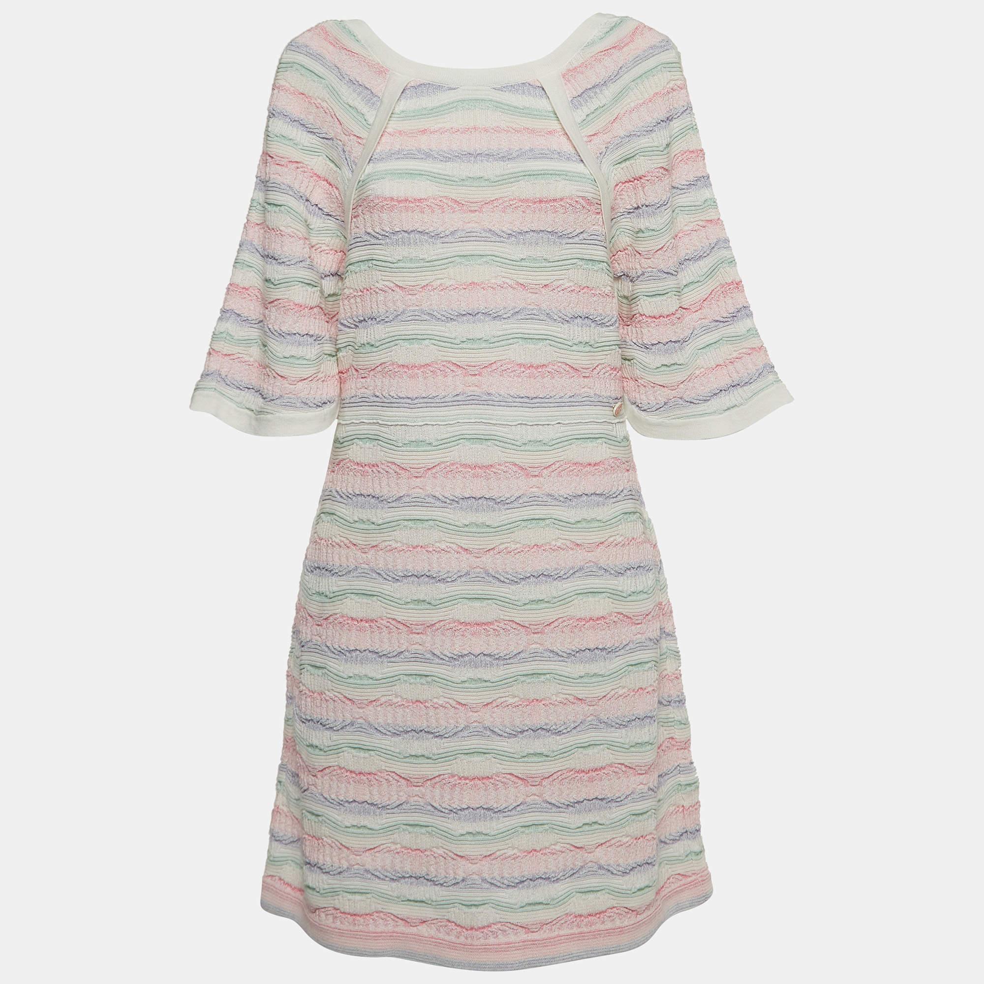 The Chanel dress is a luxurious piece featuring a harmonious blend of vibrant hues. Crafted from premium knit fabric, it boasts a flattering midi length and showcases Chanel's iconic elegance through a tasteful arrangement of multicolored stripes,