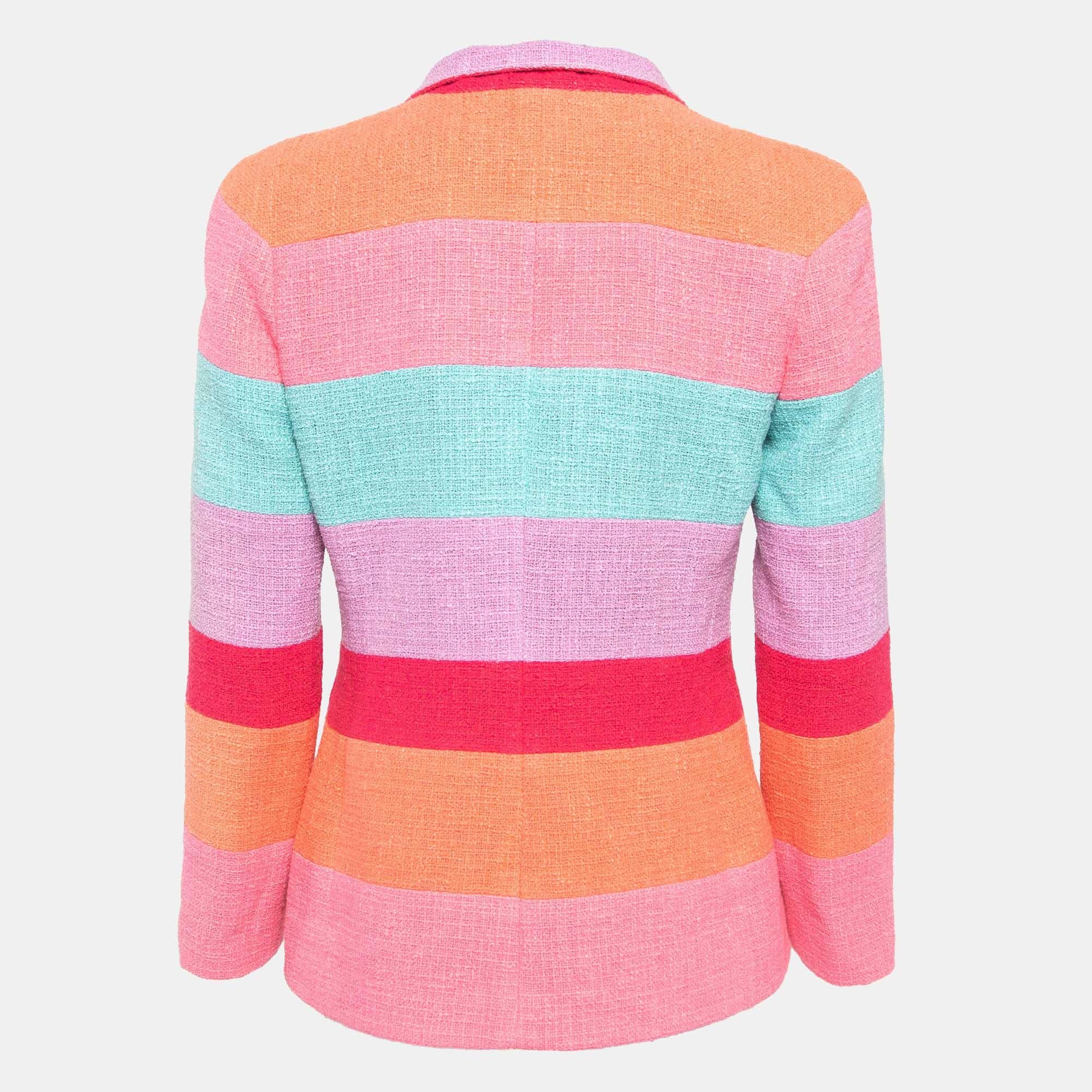 Immerse in the chic allure of the Chanel blazer. Crafted with meticulous precision, its vibrant stripes dance harmoniously on a timeless tweed canvas. Effortlessly stylish, it boasts a refined silhouette and exudes an air of undeniable