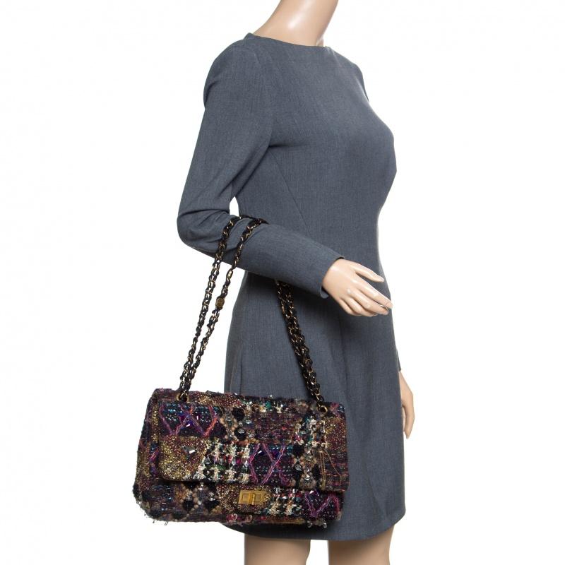 This Reissue flap bag is a buy that is worth every bit of your splurge. Exquisitely crafted from tweed it is styled with jewel embellishments on the exterior and the iconic Mademoiselle lock on the flap. The piece has gold tone hardware, and a