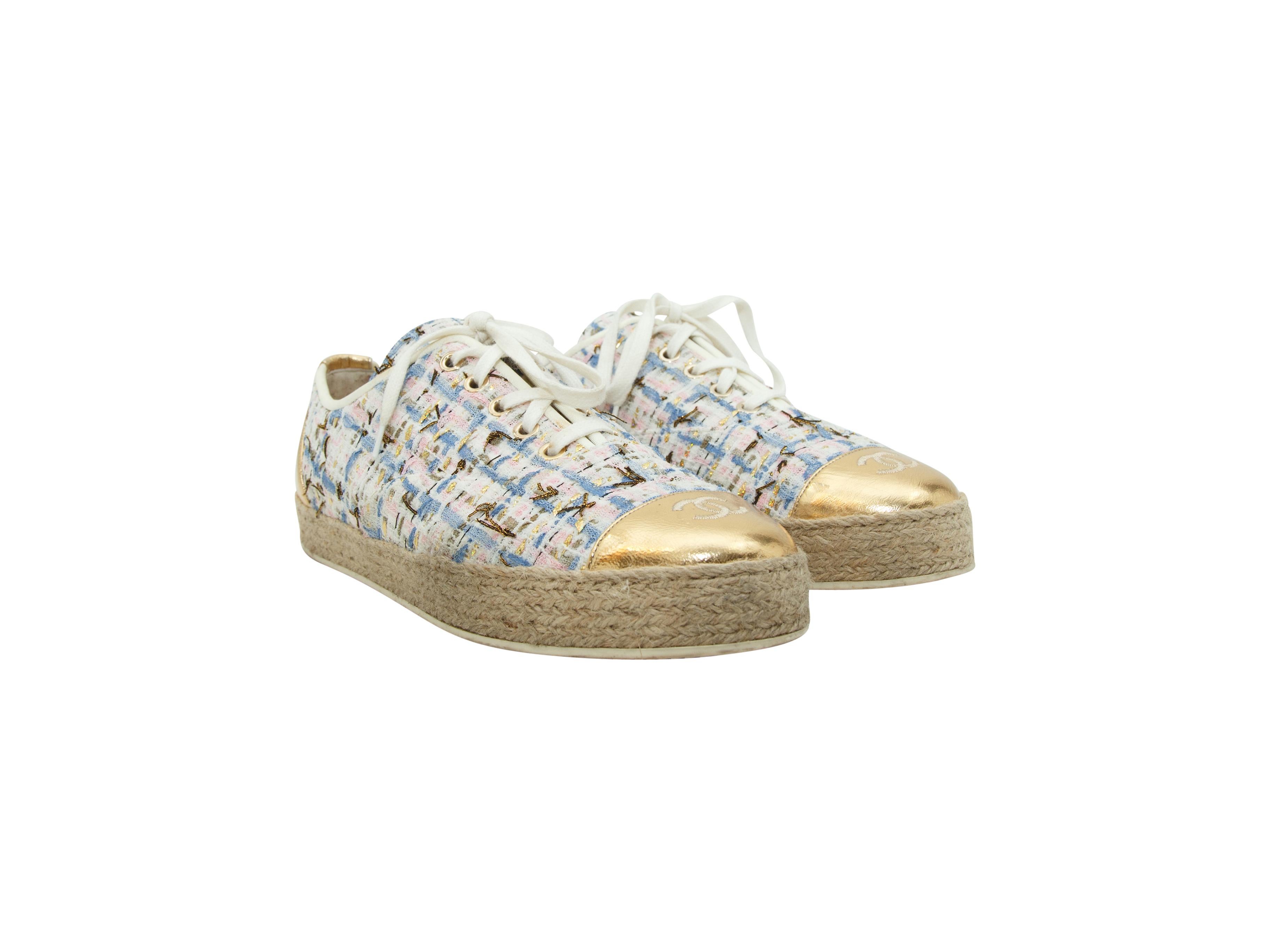 Product details:  Multicolor tweed espadrille flats by Chanel.  Trimmed with metallic gold leather.  Lace-up closure.  Round cap toe with logo detail.  1