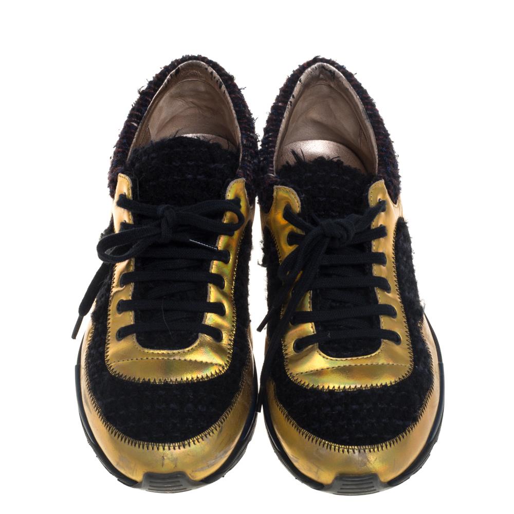 These sneakers from Chanel are so chic, you'll love wearing them for your fun outings! The multicolor sneakers are crafted from tweed fabric, suede, and leather and shaped into round toes. They flaunt lace-ups on the vamps and the CC logo on the