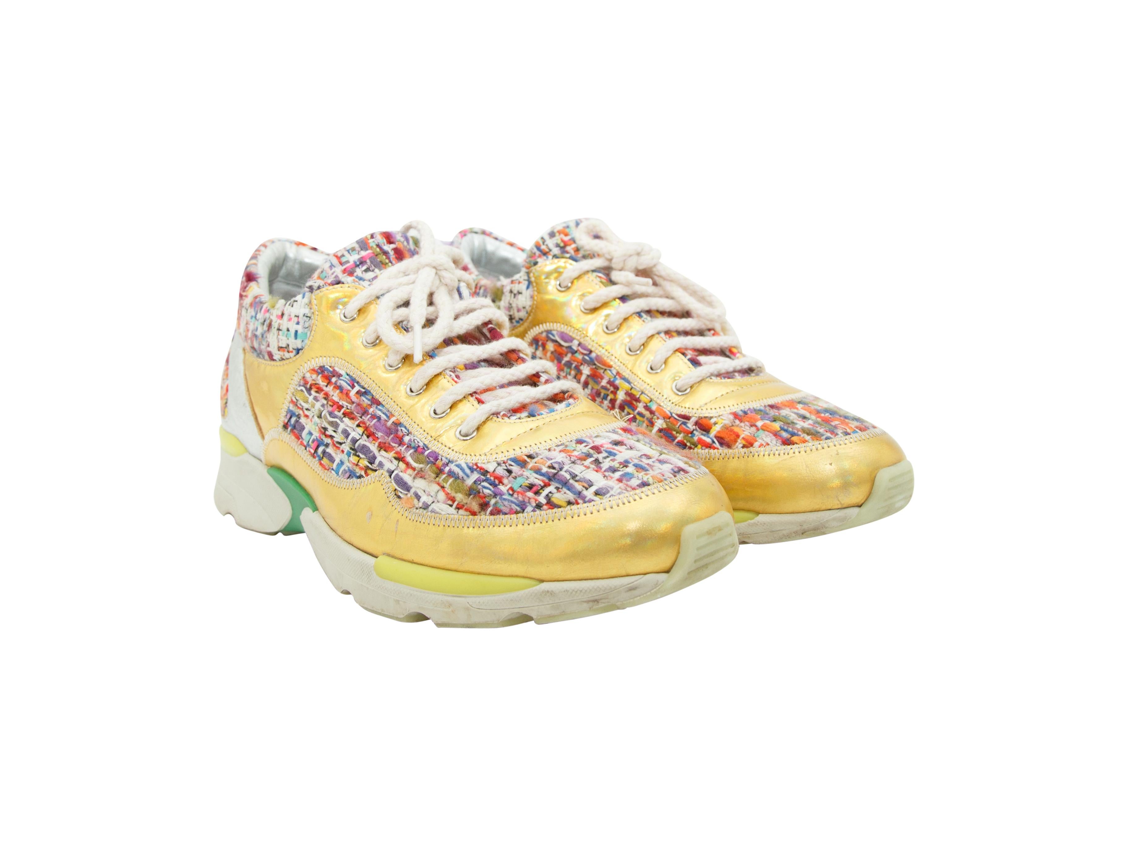 Product details:  Multicolor tweed sneakers by Chanel.  Trimmed with iridescent yellow leather.  Lace-up closure.  Round toe.  
Condition: Pre-owned. Very good.
Est. Retail $ 995.00