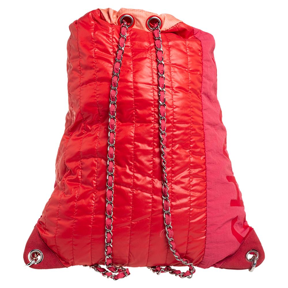 This lightweight and convertible backpack by Chanel has vertical quilting and the CC turn-lock detail. The multicolored nylon bag features a drawstring closure, interwoven shoulder straps and a spacious interior. It is complete with a nylon-lined