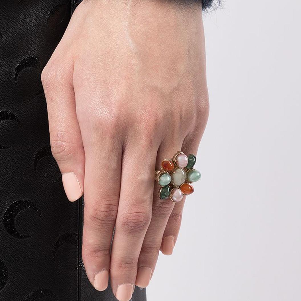 Inspired by the camellia flower, this pre-owned stone ring displays a central white stone surrounded by blue and pink faux pearls and red and green stones resting on a gold-toned band. Wear it solo on your index or middle finger for the most