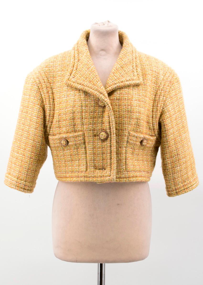 Chanel mustard tweed crop jacket. Button closure with wooden and tweed detail. 

27% Wool, 26% Polyamide, 25% acrylic, 12% Viscose,

Approx.

Shoulder width: 44 cm 

Sleeve length: 34 cm 

Length: 40 cm 