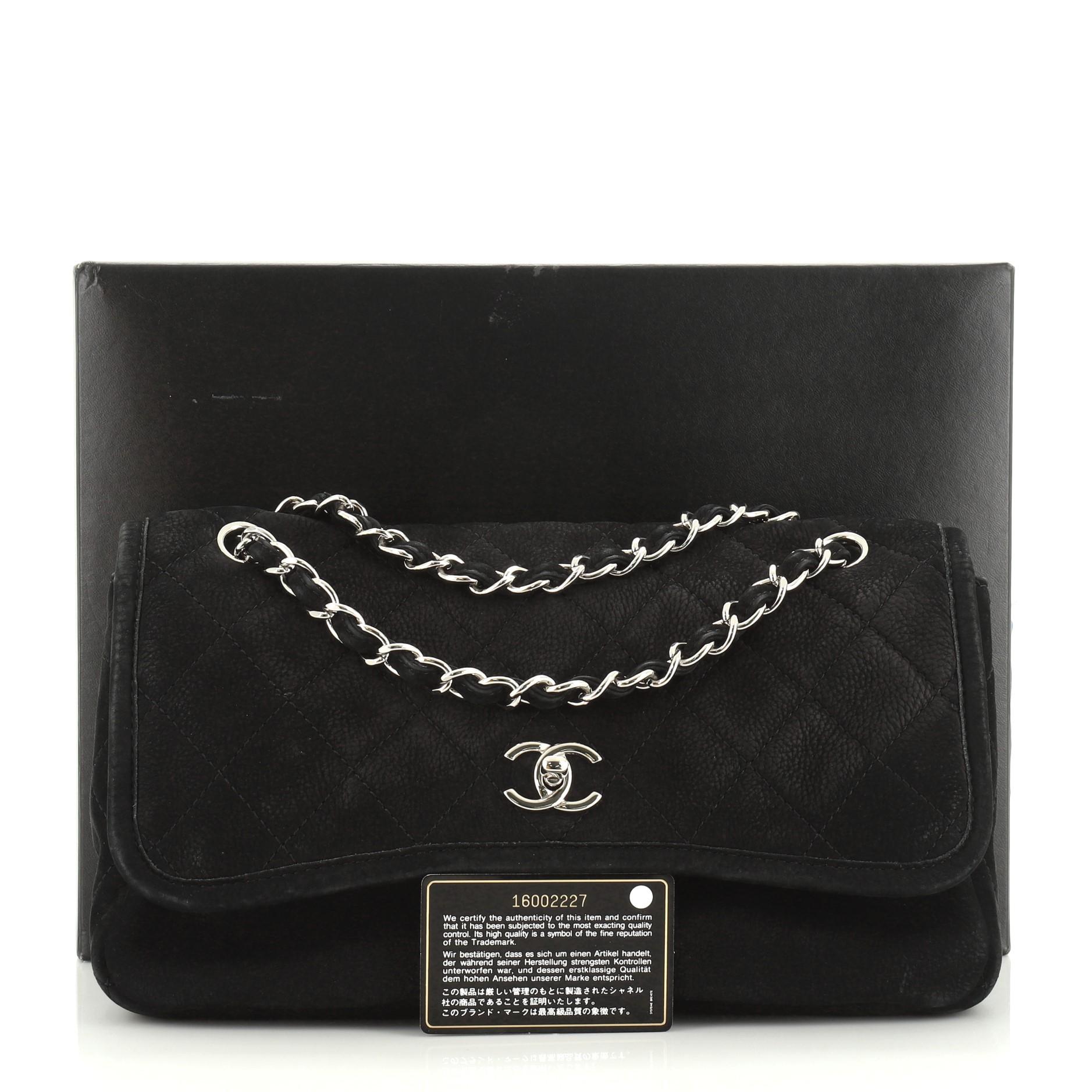 This Chanel Natural Beauty Split Pocket Flap Bag Quilted Nubuck Large, crafted in black quilted nubuck, features woven-in leather chain straps, two slip pockets under flap and silver-tone hardware. Its CC turn-lock closure opens to a black fabric