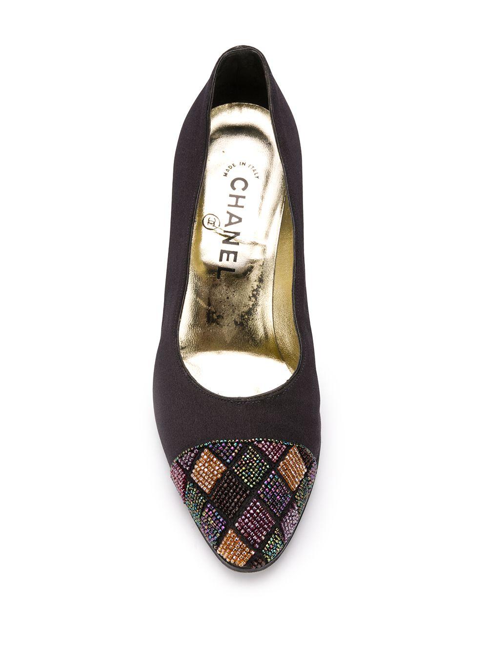Crafted in Italy from a combination of smooth black and cream calf leather, these vintage pumps by Chanel are for the fashion forward, featuring a mid high stiletto heel, a comfortable slip-on style and a myriad of colourful, beaded embellishments
