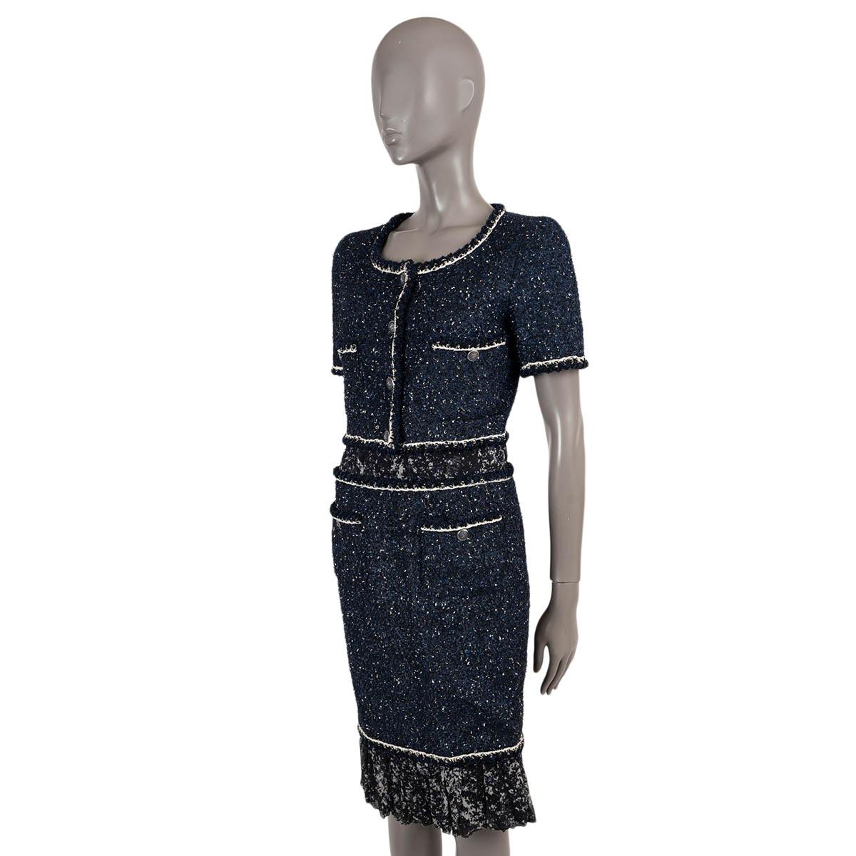 100% authentic Chanel panelled tweed dress in navy blue and black acrylic (43%), nylon (23%), polyester (20%) and viscose (14%). Features printed silk waist insert and flared bottom hem, a scoop neck, short sleeves, decorative button front and four
