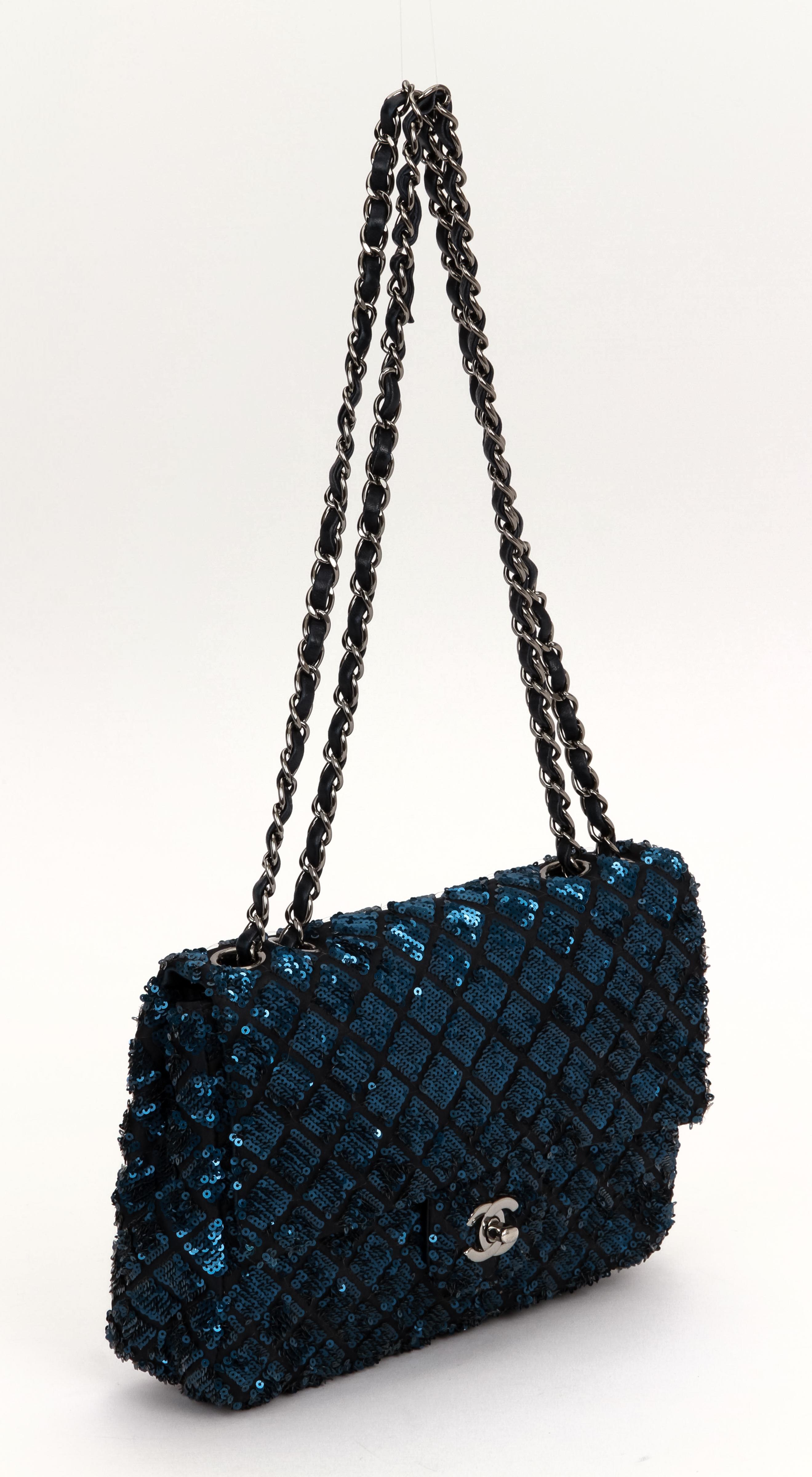 Chanel quilted black silk and blue sequins single-flap evening bag with silvertone hardware. Can also be worn as a crossbody. Leather interior. Shoulder drop, 12