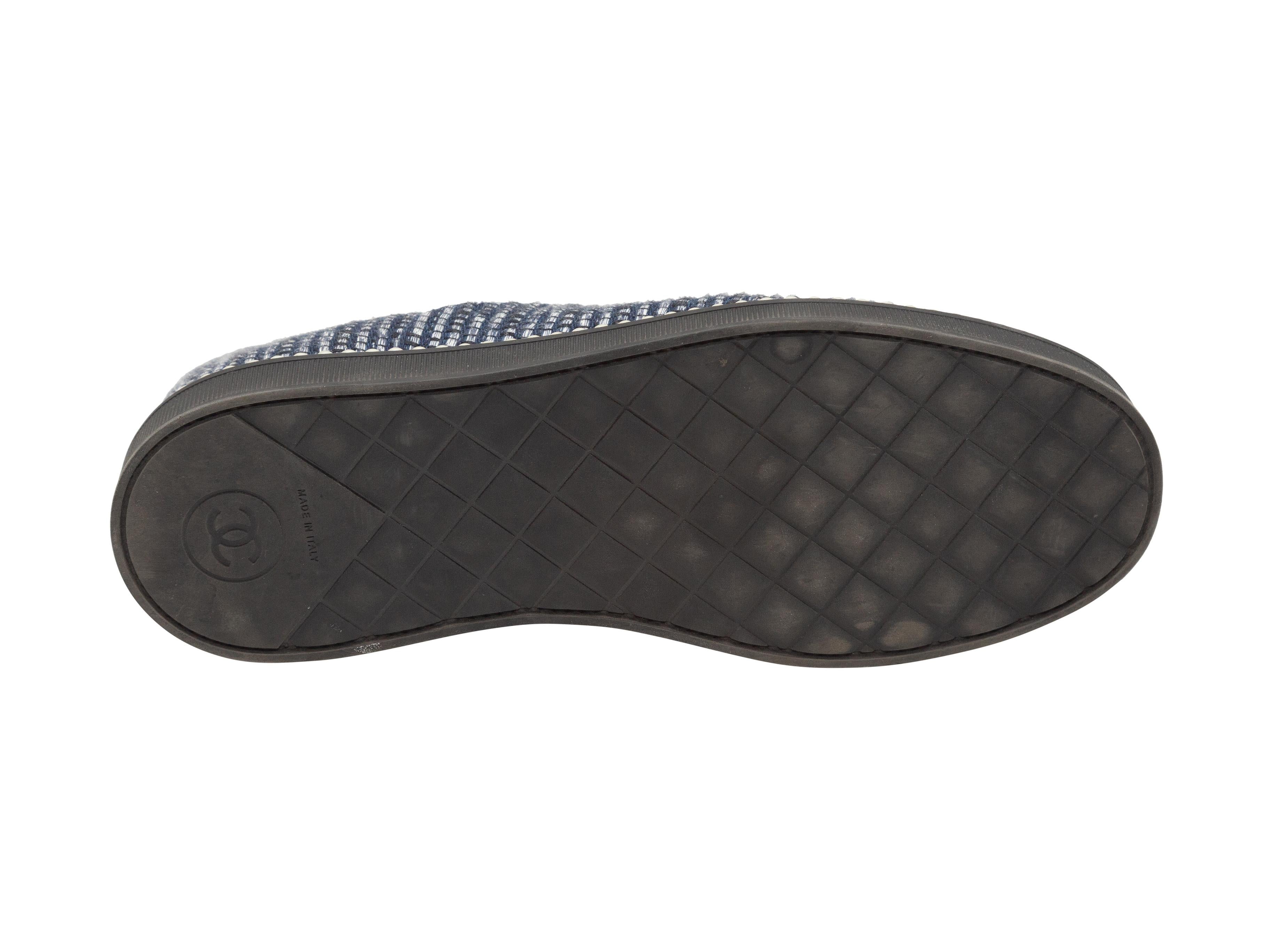 Product details: Navy and black tweed and grosgrain cap-toe low-top sneakers by Chanel. Faux pearl trim throughout. Rubber soles. Lace-up tie closures at tops. Designer size 38. 1.25