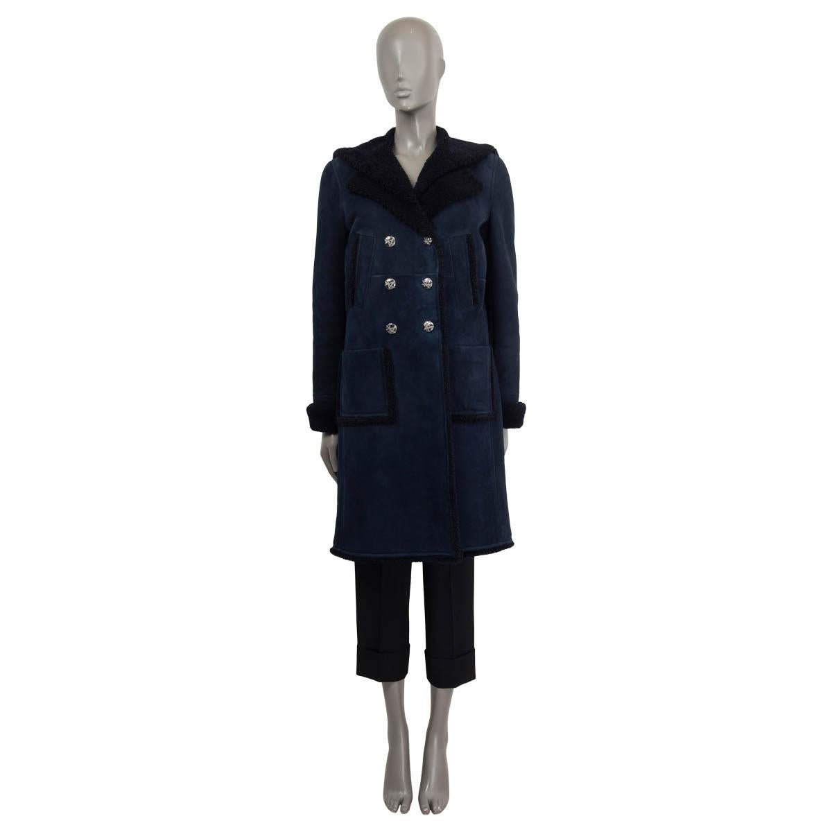 100% authentic Chanel 2018 Hamburg double breasted coat in navy dyed lamb shearling (100%). Features two chest pockets and two patch pockets on the front. Has a sailors flap and a belt on the back. Opens with silver-tone 'CC' buttons on the front.