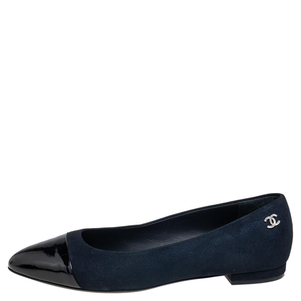 These ballet flats from the House of Chanel are truly elegant and poised. They are made from navy-blue, black suede and patent leather and showcase cap toes. A petite silver-toned logo is used to embellish the upper. They are made in a slip-on