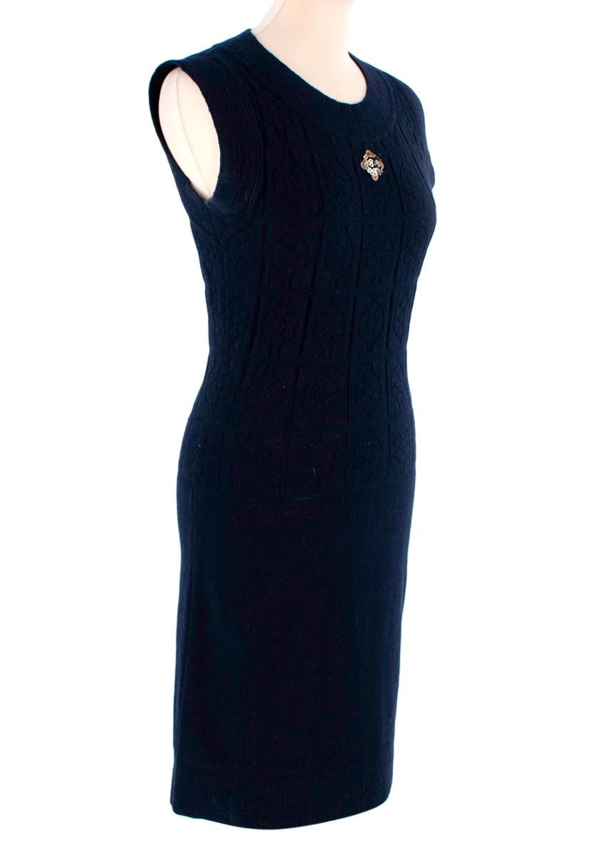 Chanel Navy Blue Cable Knit Sleeveless Dress
 

 - Soft wool-cashmere blend fine knit, in a linear cable pattern
 - Round neck, sleeveless style with ribbed hems
 - Embellished CC logo motif on the chest rendered in relief on gold bead and sequin