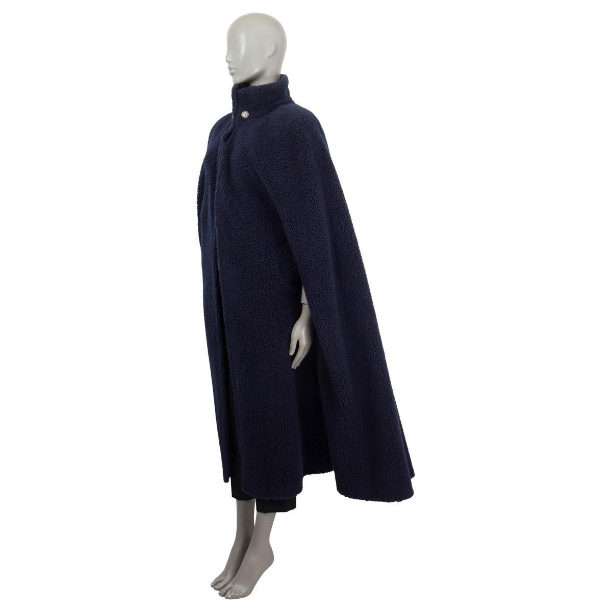100% authentic Chanel long teddy cape in navy blue cashmere (82%) and silk (18%). Lined in navy blue wool (100%). Cloeses with a hook by the neck and features two blue stone embellished buttons. Has been worn and is in excellent condition. 

2019