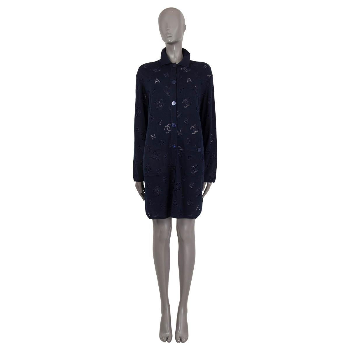 100% authentic Chanel collared oversized long cardigan in navy blue cotton (70%) and cashmere (30%). Features logo broderie anglaise embroidery and two patch pockets on the front. Closes with CC mother-of-pearl buttons on the front. Has been worn