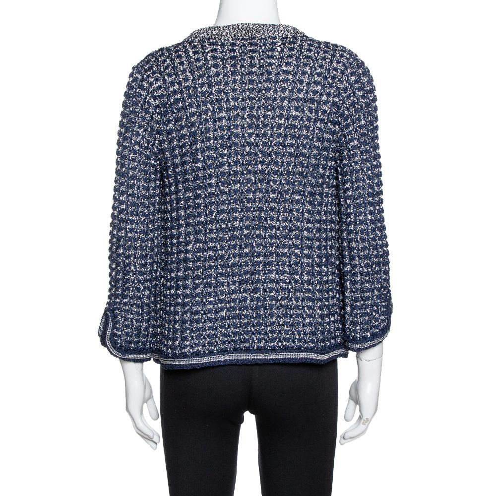 Look incredibly chic and stylish in this navy blue Chanel jacket. Knitted from a blend of fabrics, it is created in a crochet pattern and has an interesting chain detail at the front. Finished with long sleeves, incorporate this exquisite jacket