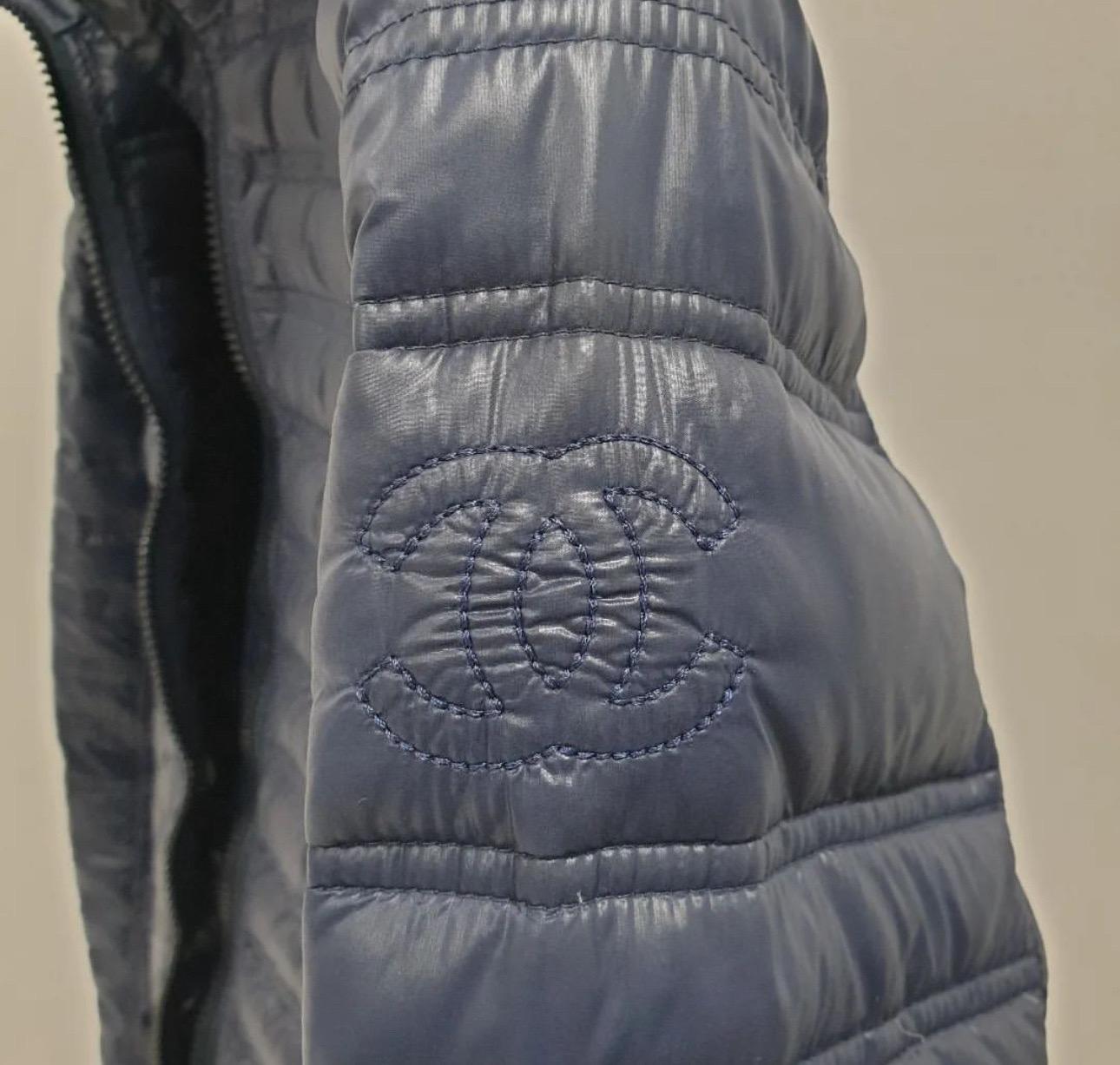 Chanel quilted 100% down puffer jacket from 2009 collection. 
This is rare to find. 
It is pre-owned in mint condition. Signs of wear seen on pics.
It is adorned with embroidered Chanel interlocking CC logo at left sleeve,  2 pockets at sides and