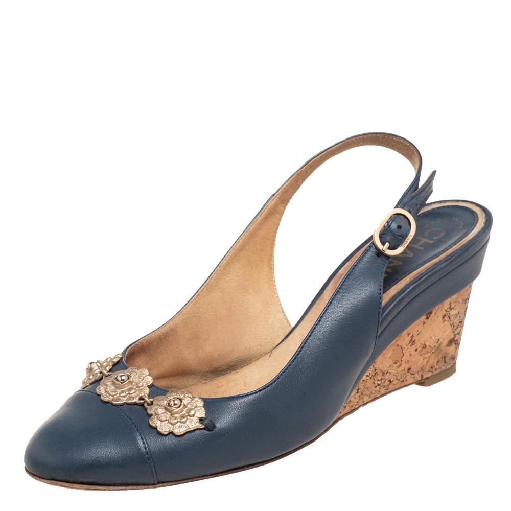 Charm your way to all your social gatherings in this pair of sandals from Chanel. Crafted from leather, they carry a feminine silhouette with Camellia motifs perched on the front, buckle-held slingback, and a wedge heel. 