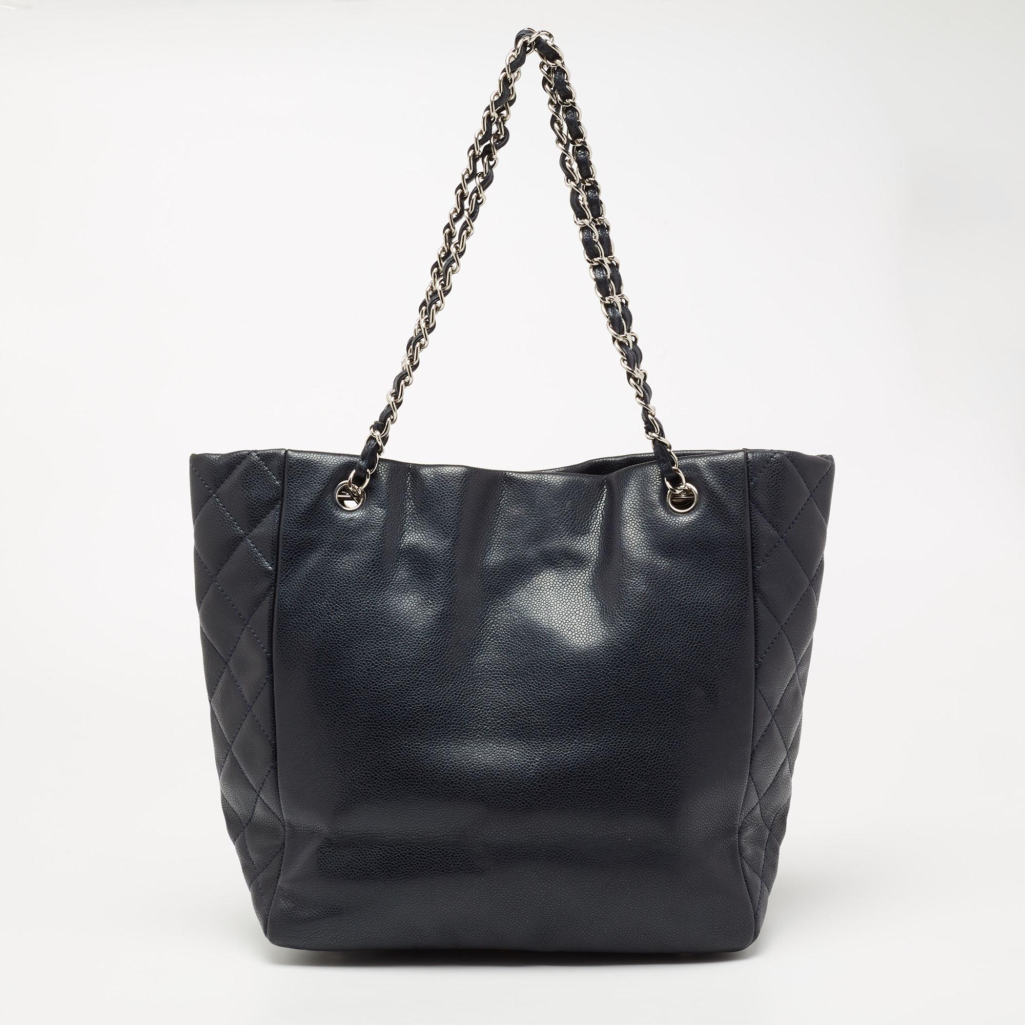 A stylish tote is an everyday staple for all fashionistas! This bag from the house of Chanel is crafted from leather and covered in its timeless quilt pattern on the sides. The piece reveals a capacious fabric interior. It is truly sleek and