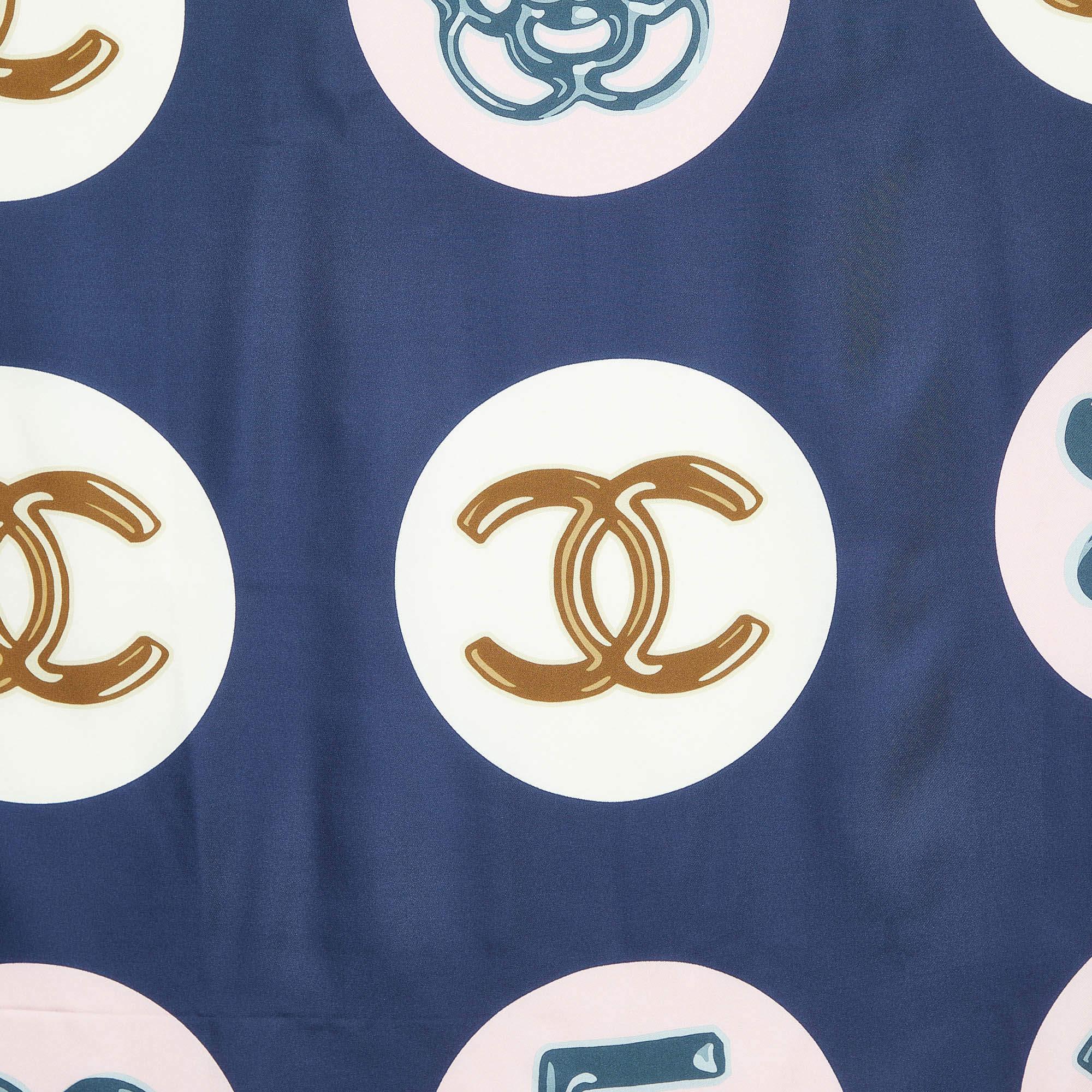 Elevate your style with this meticulously crafted Chanel silk scarf. Prints and timeless design unite for an exquisite accessory that exudes sophistication and style.